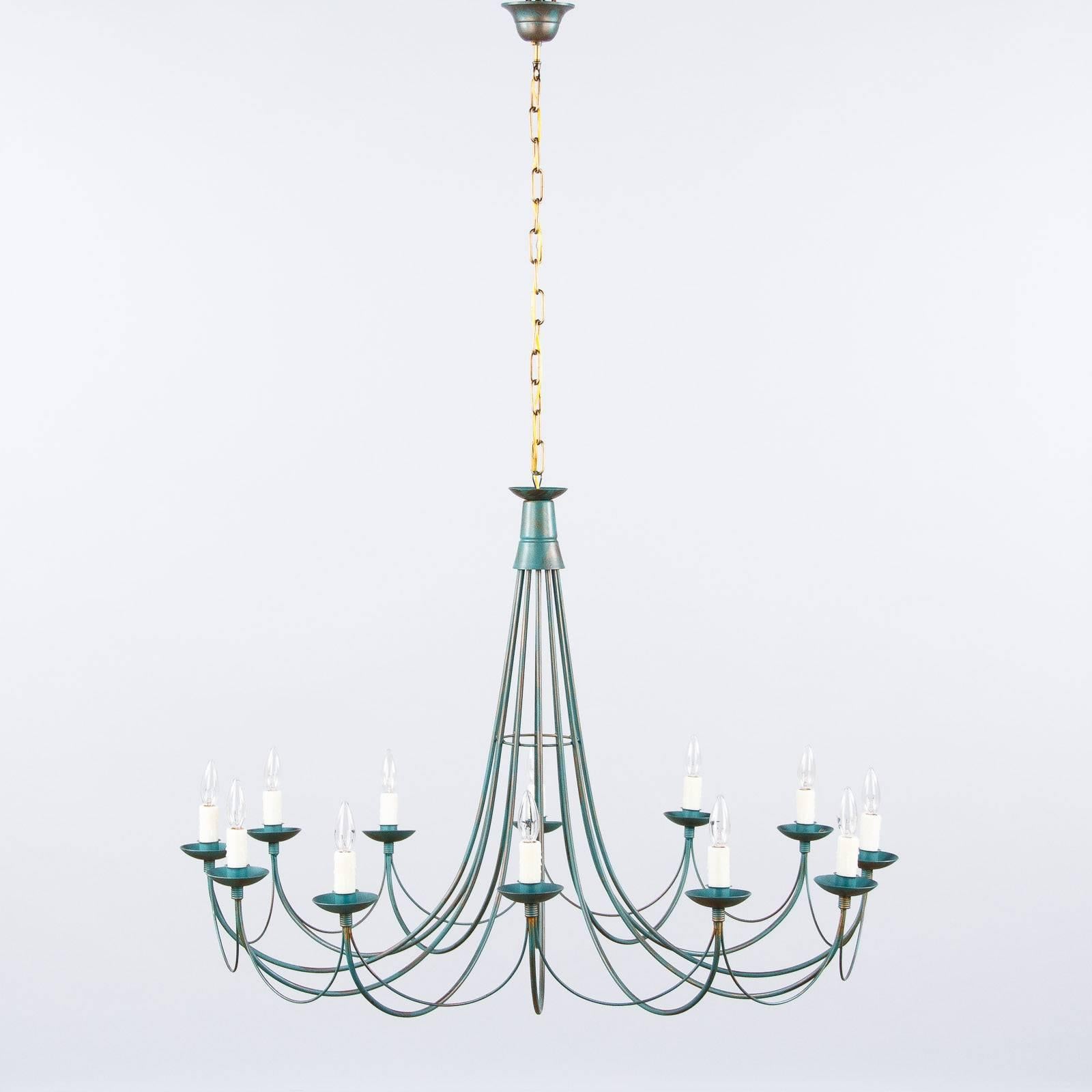 A large twelve-light chandelier made of painted metal in green tones purchased in the Beaujolais Region of France. This modern fixture, circa 1980s, features curved arms and is rewired for candelabra base bulbs up to 40 watts each. The adjustable