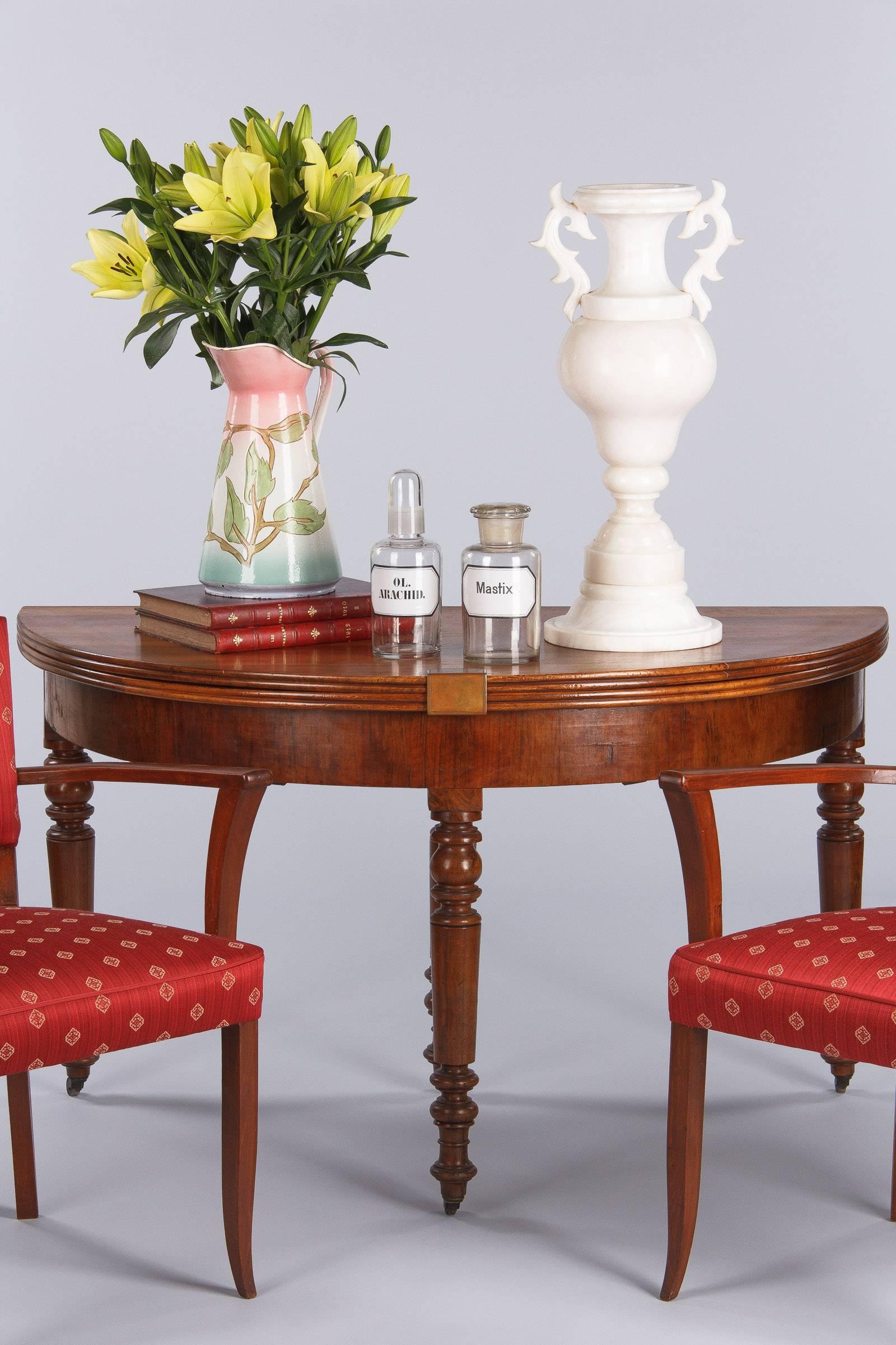 A handsome period Louis Philippe demilune table in French blond walnut that opens up to a round table of 50.75