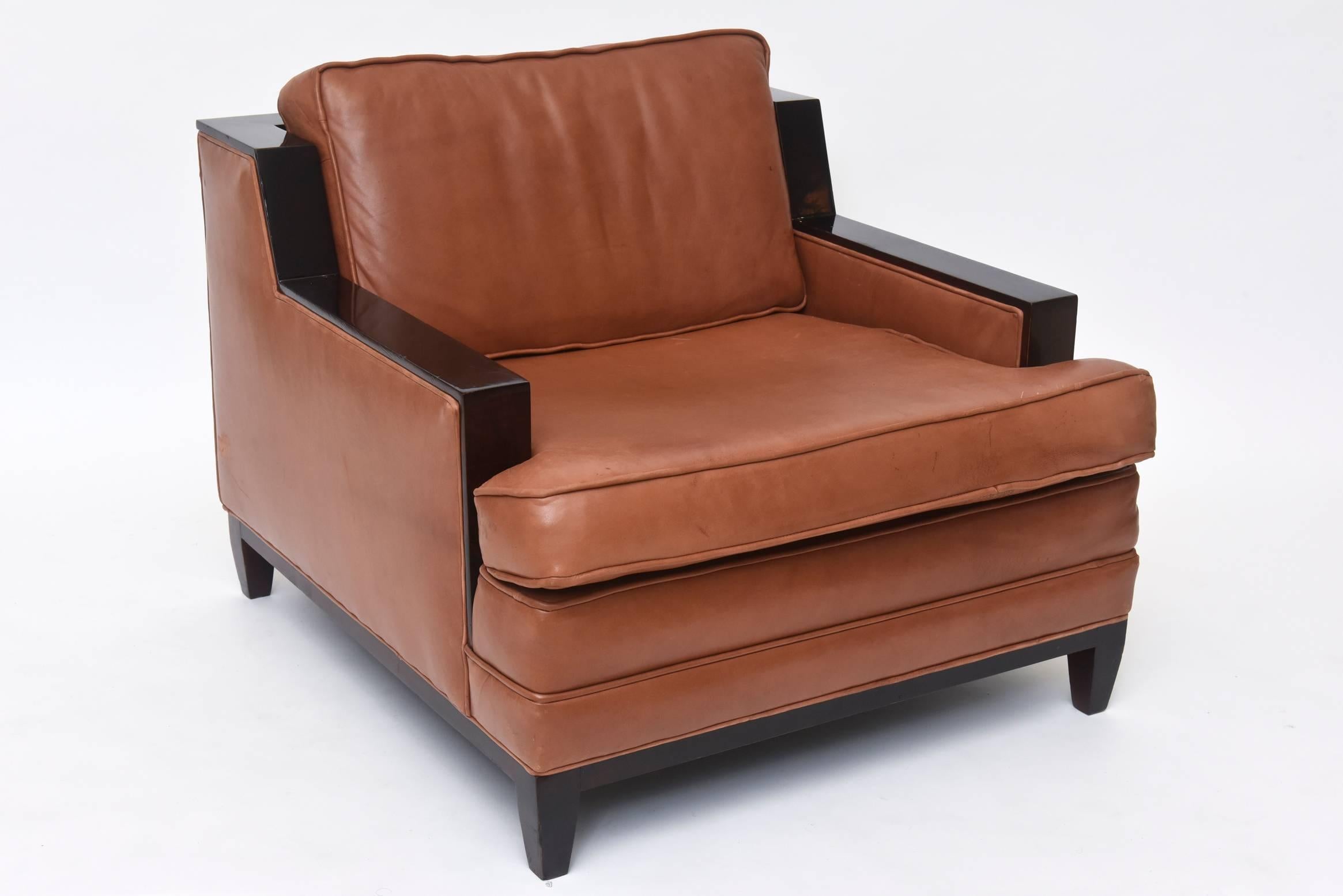 Pair of mahogany chestnut-colored leather lounge chair attributed to Jacques Adnet known for his elegant and luxurious Art Deco designs, 1940s.

  
