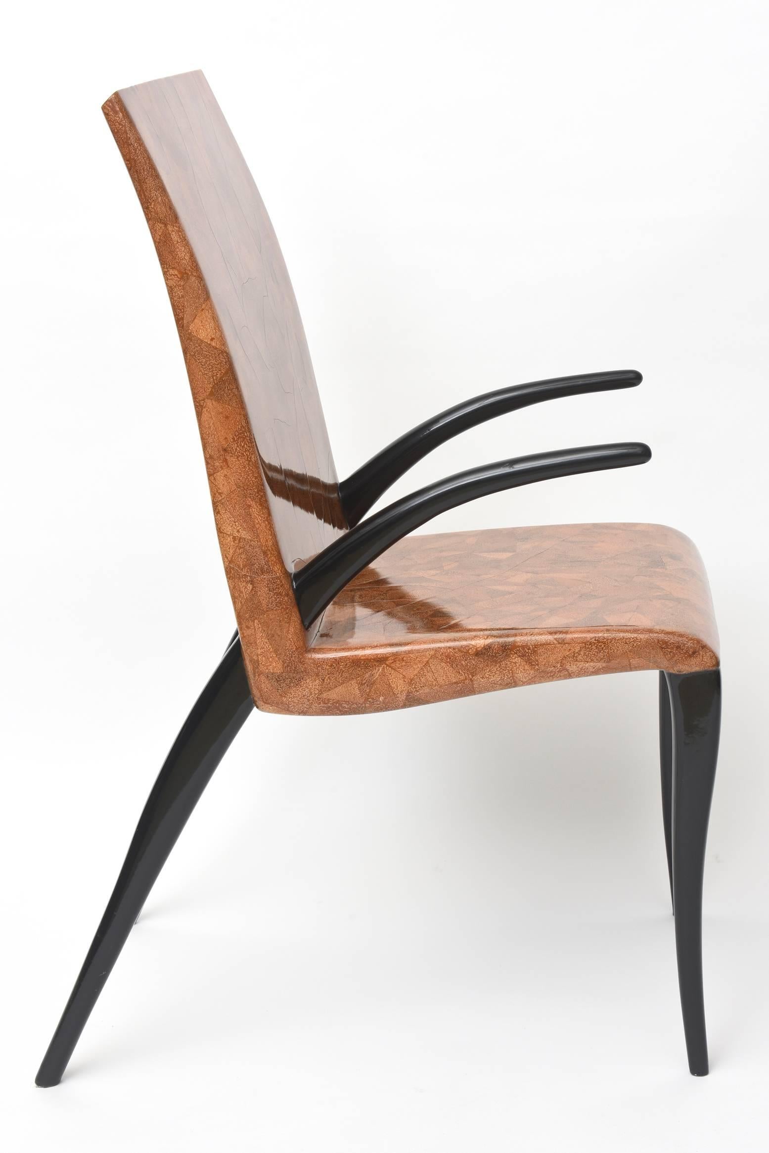 The back and seat of coconut and tobacco under resin, the arms and legs of ebony wood, metal label R & Y Augousti- Paris.