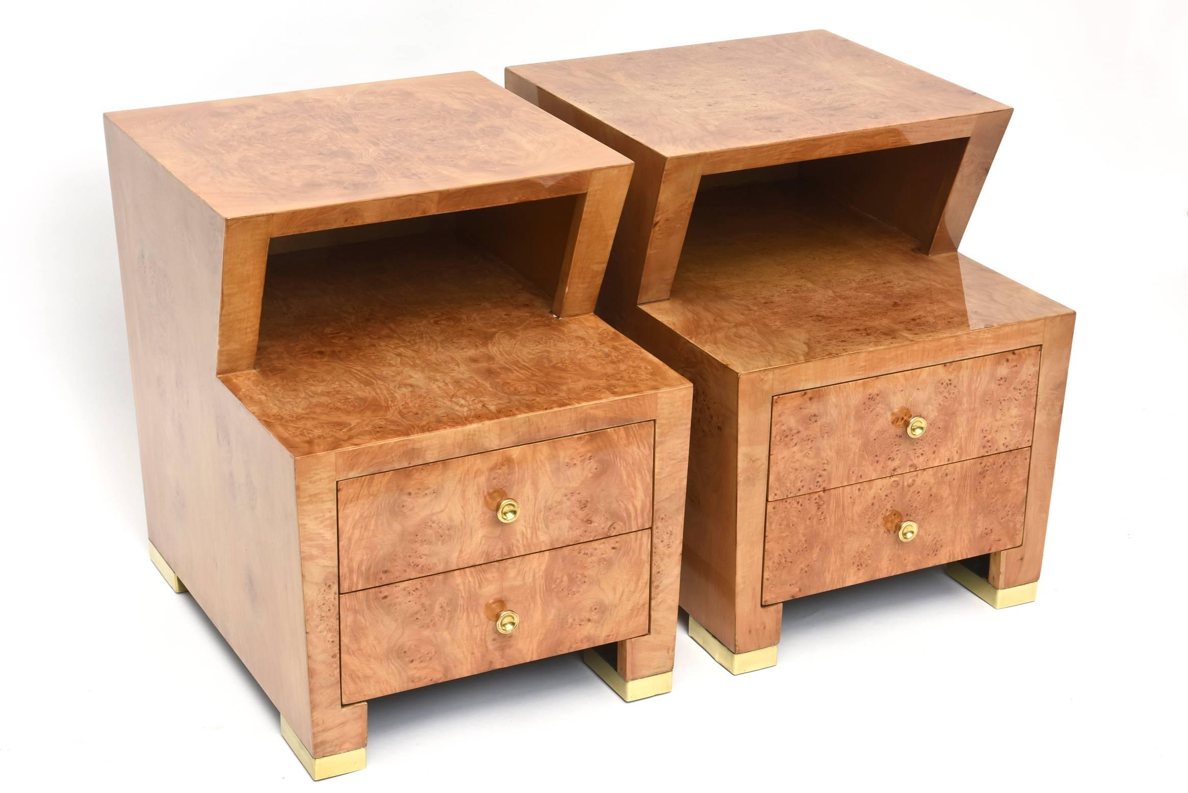 The square top above a canted cut-out above two drawers on brass feet.