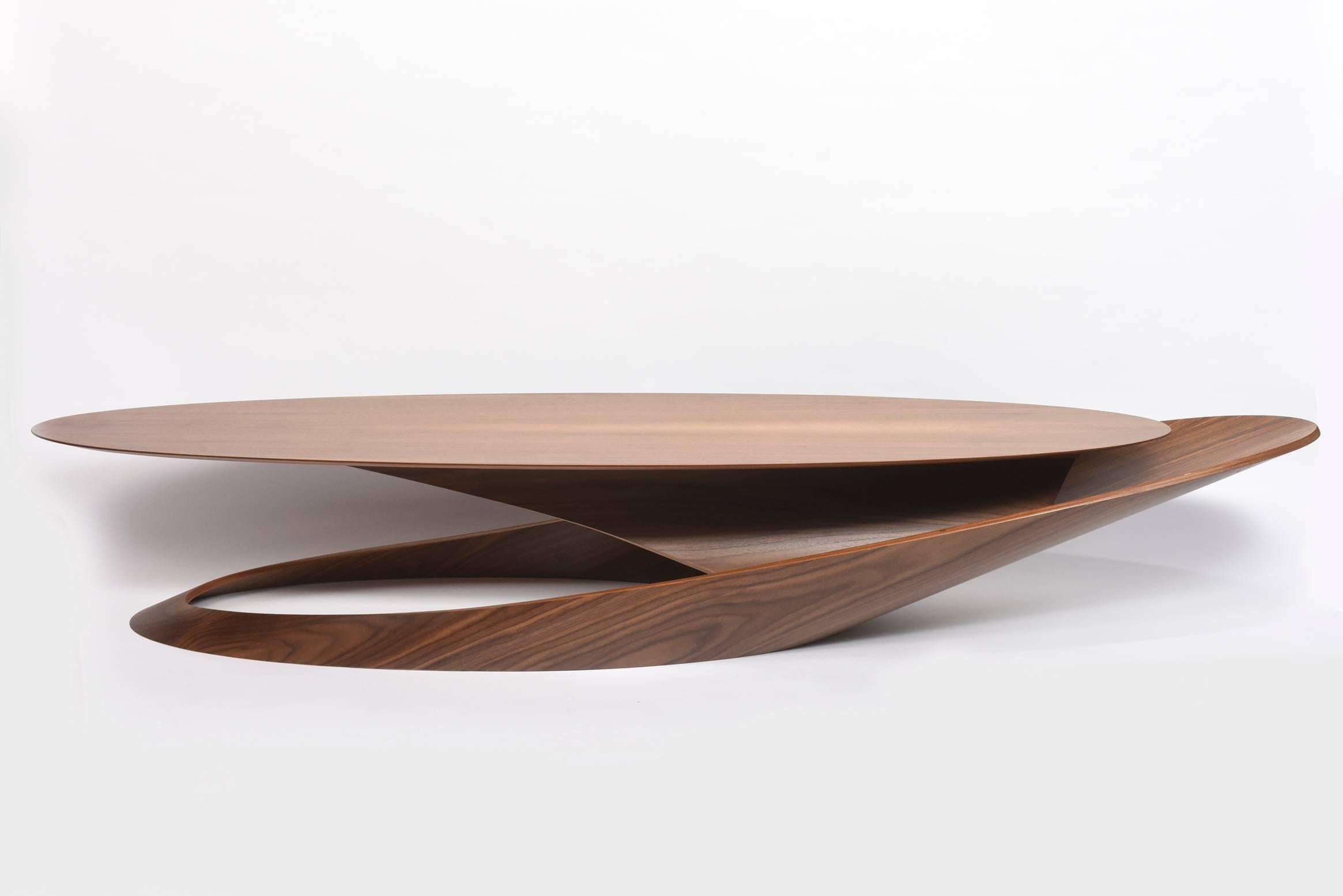 Overall in Italian walnut, the oval top cantilevered above an architectural base- this is handmade and a unique piece- most pieces are in an edition of 10, but this is a prototype.