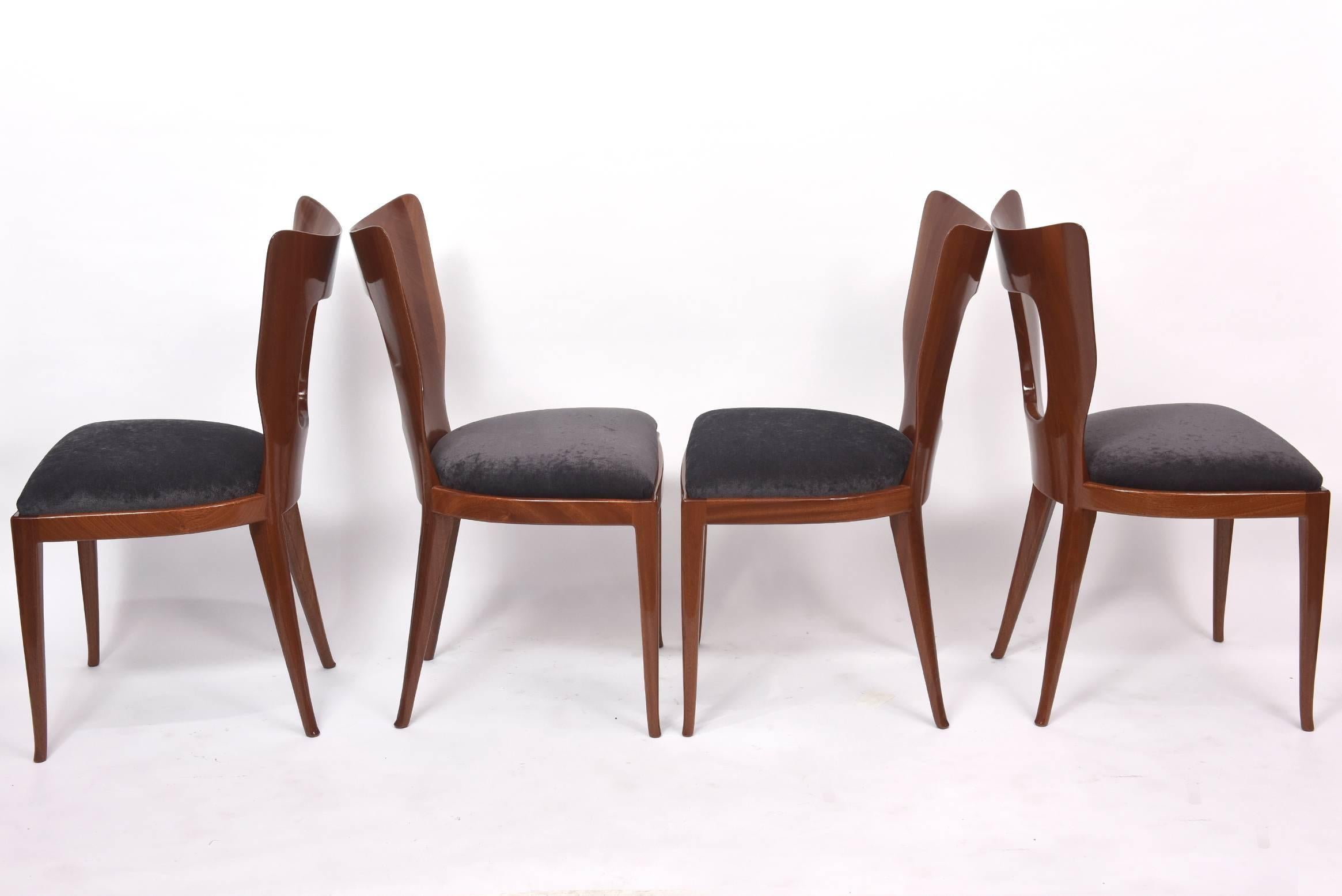 The curved back with geometric cut-out, on round tapering splayed legs, each with metal label, atelier borsani.