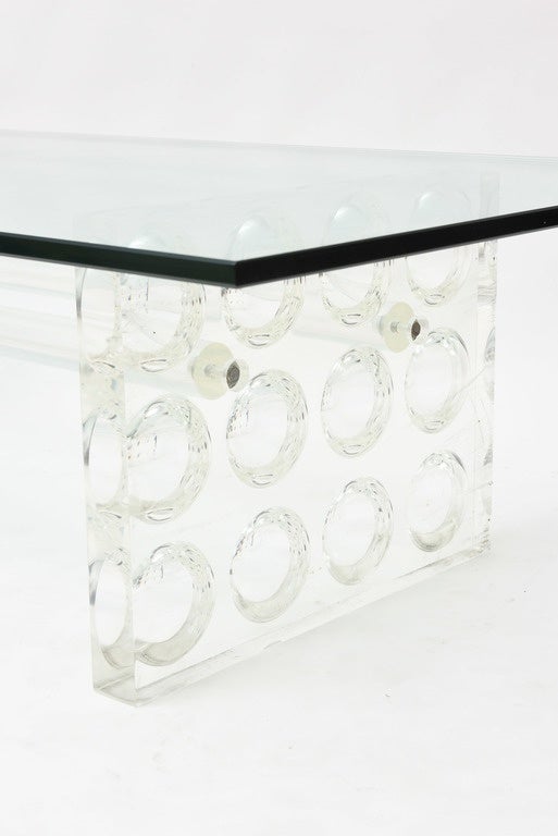 The glass over Lucite side supports with circular bubble motif with a cross stretcher.