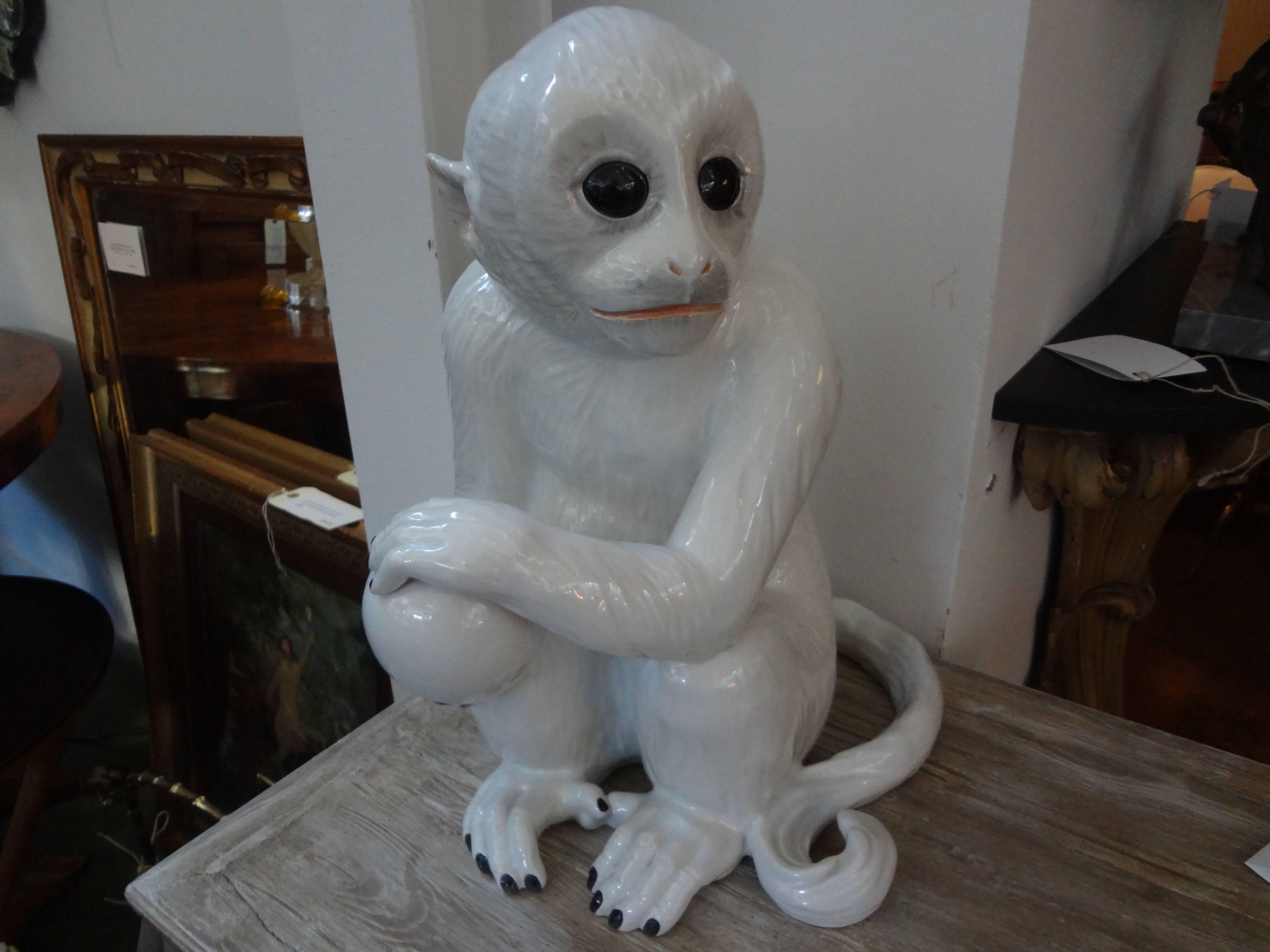 Italian mid-century Hollywood Regency white glazed pottery sculpture of a monkey, marked Italy, circa 1960.