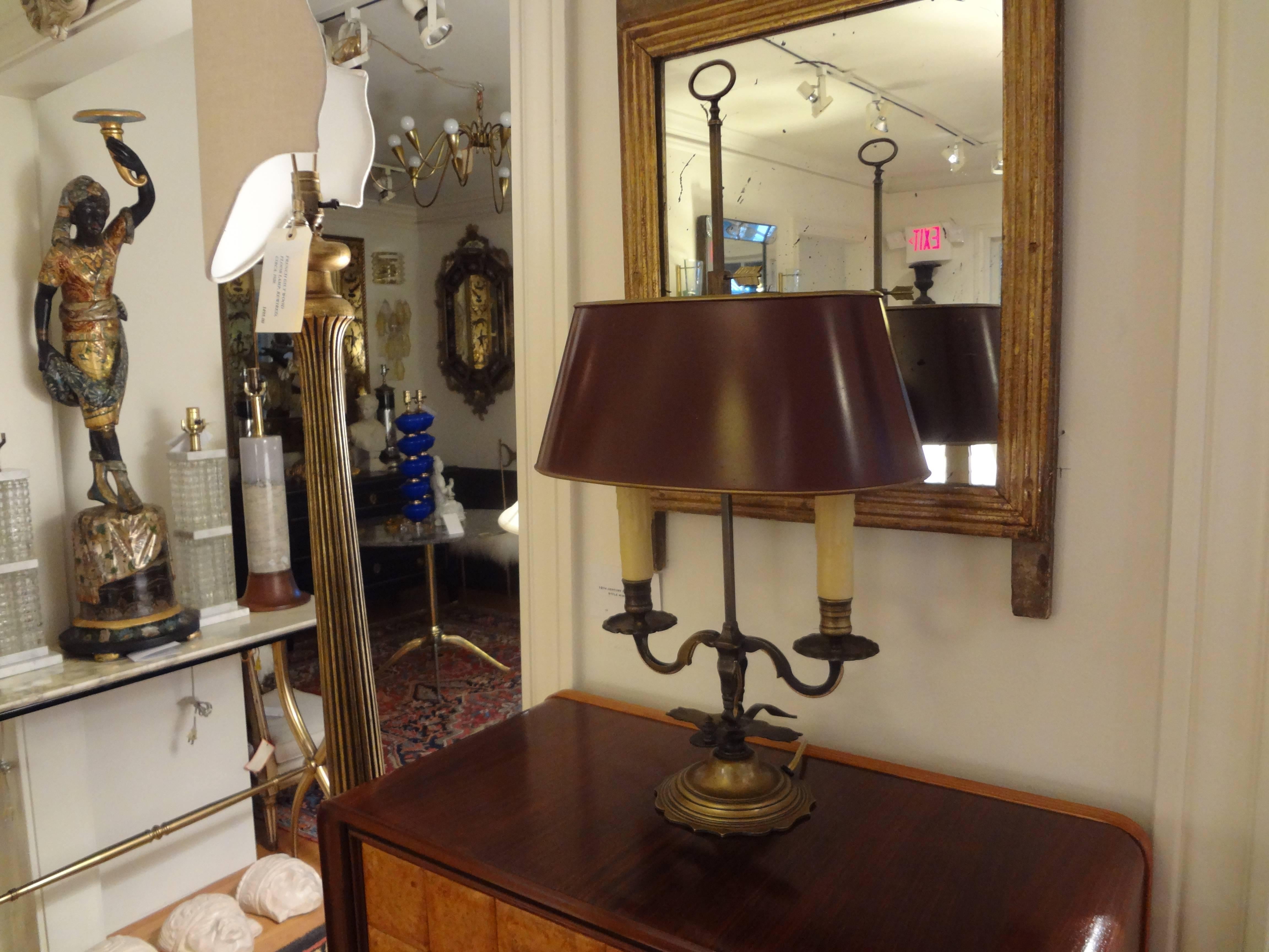 Lovely antique French neoclassical style bronze two-light bouillotte lamp or desk lamp with burgundy tole shade. This lovely French desk lamp has been wired for the U.S. market with candle sleeves.