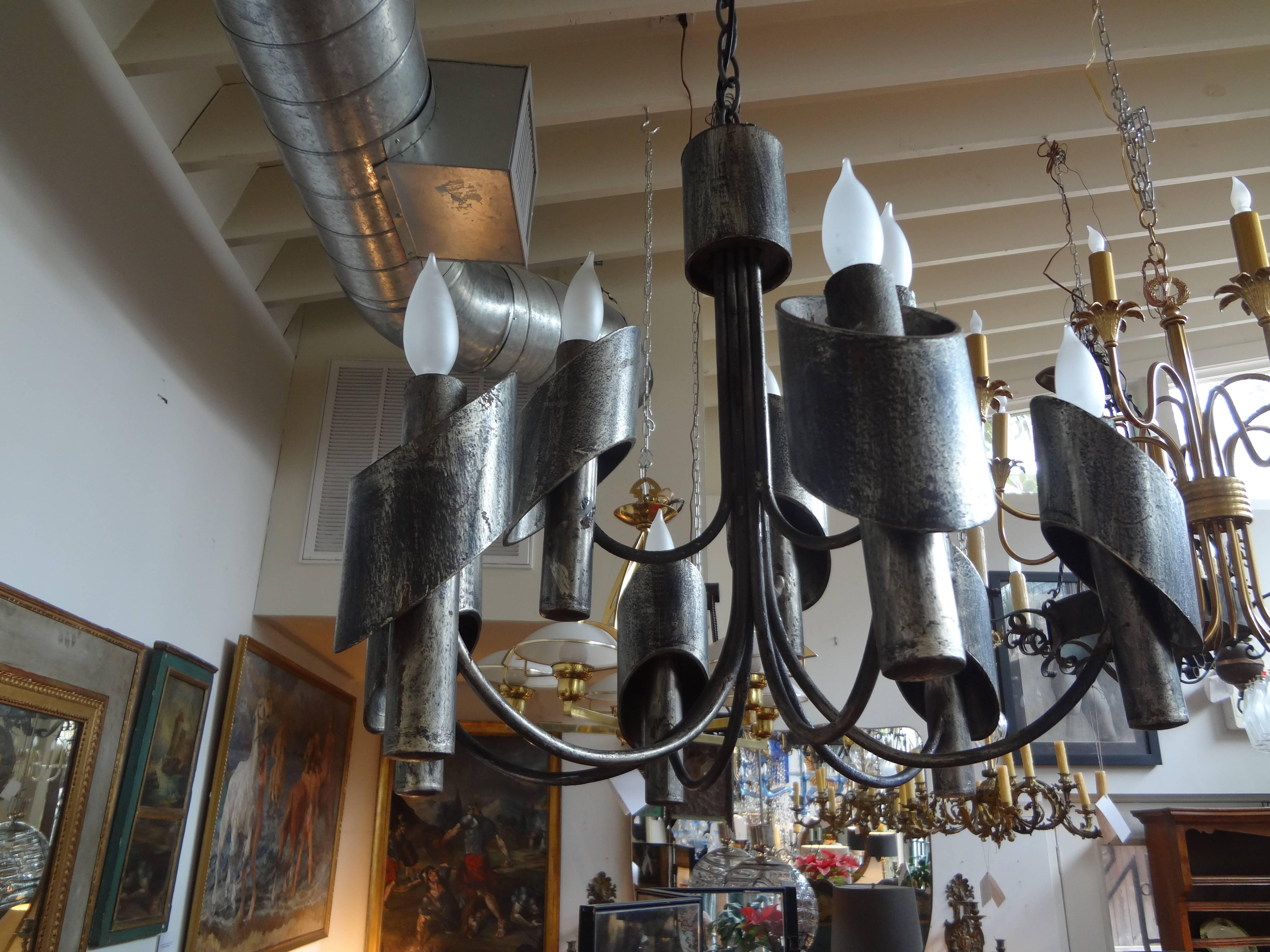 Italian Gaetano Sciolari style chandelier in the Brutalist style. This sculptural steel chandelier of patinated steel is newly wired for the U.S. Market.
This Italian midcentury chandelier dates to the 1960s.
Approximate dimensions:
Body of