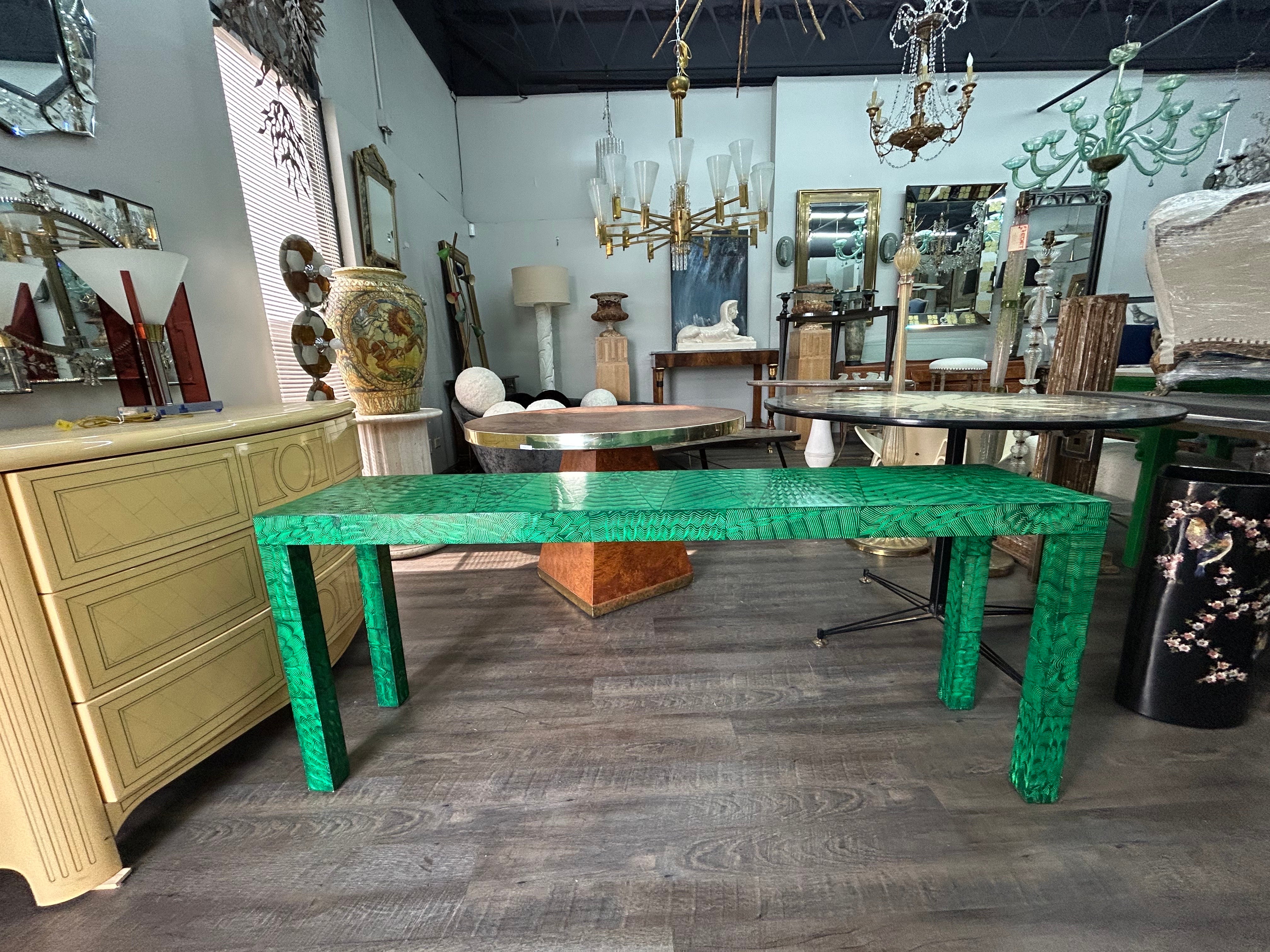 Faux Malachite Console Table.
Offered is a stunning 20th century faux malachite console table or sofa table.
This versatile Hollywood Regency table is decorated on all sides making it a great candidate for floating in a room as it's lovely at every