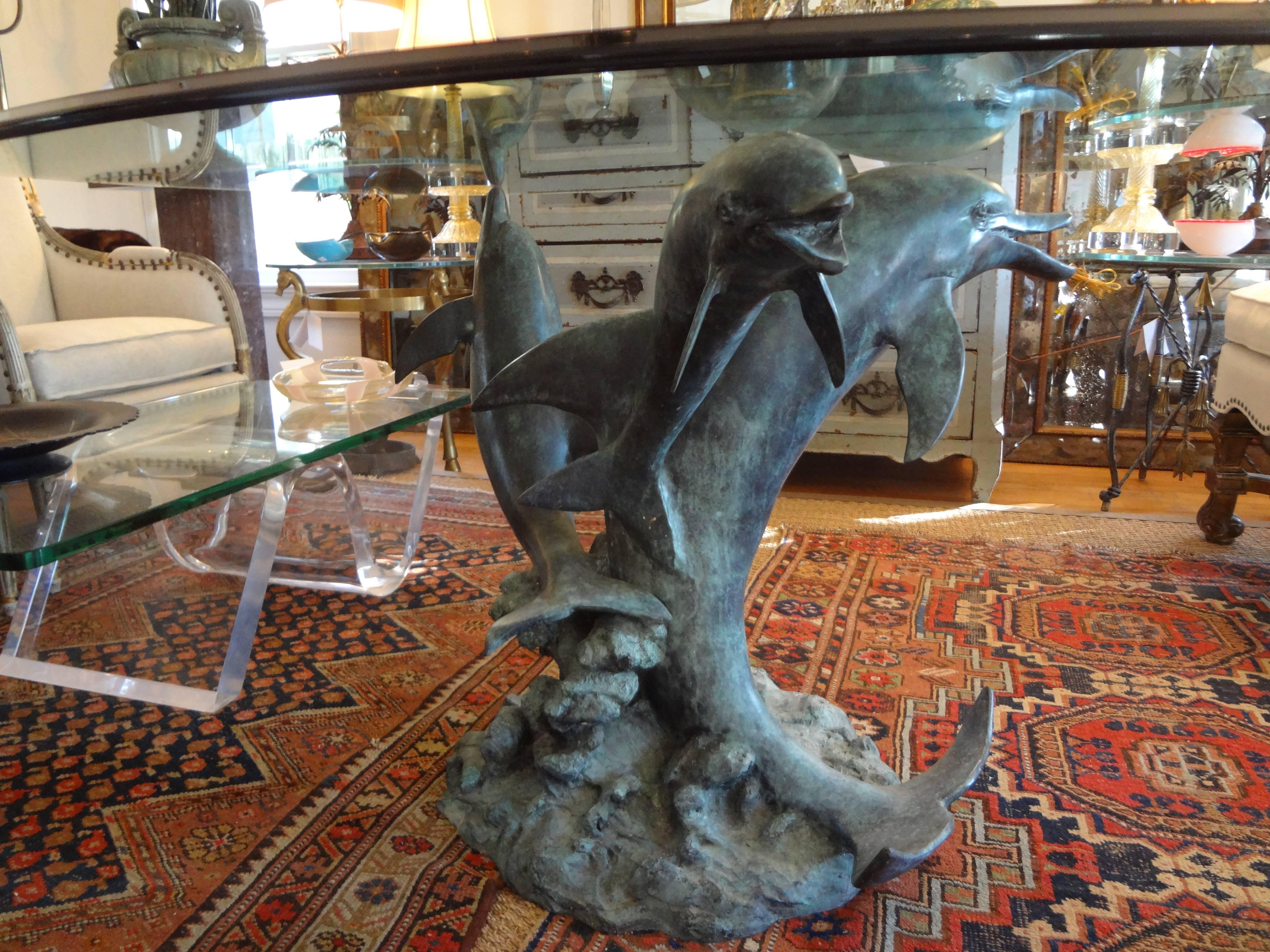 Extremely realistic center table comprised of three patinated dolphins emerging from the water below with a glass top.

Please click KIRBY ANTIQUES logo below to view additional pieces from our vast inventory.

          