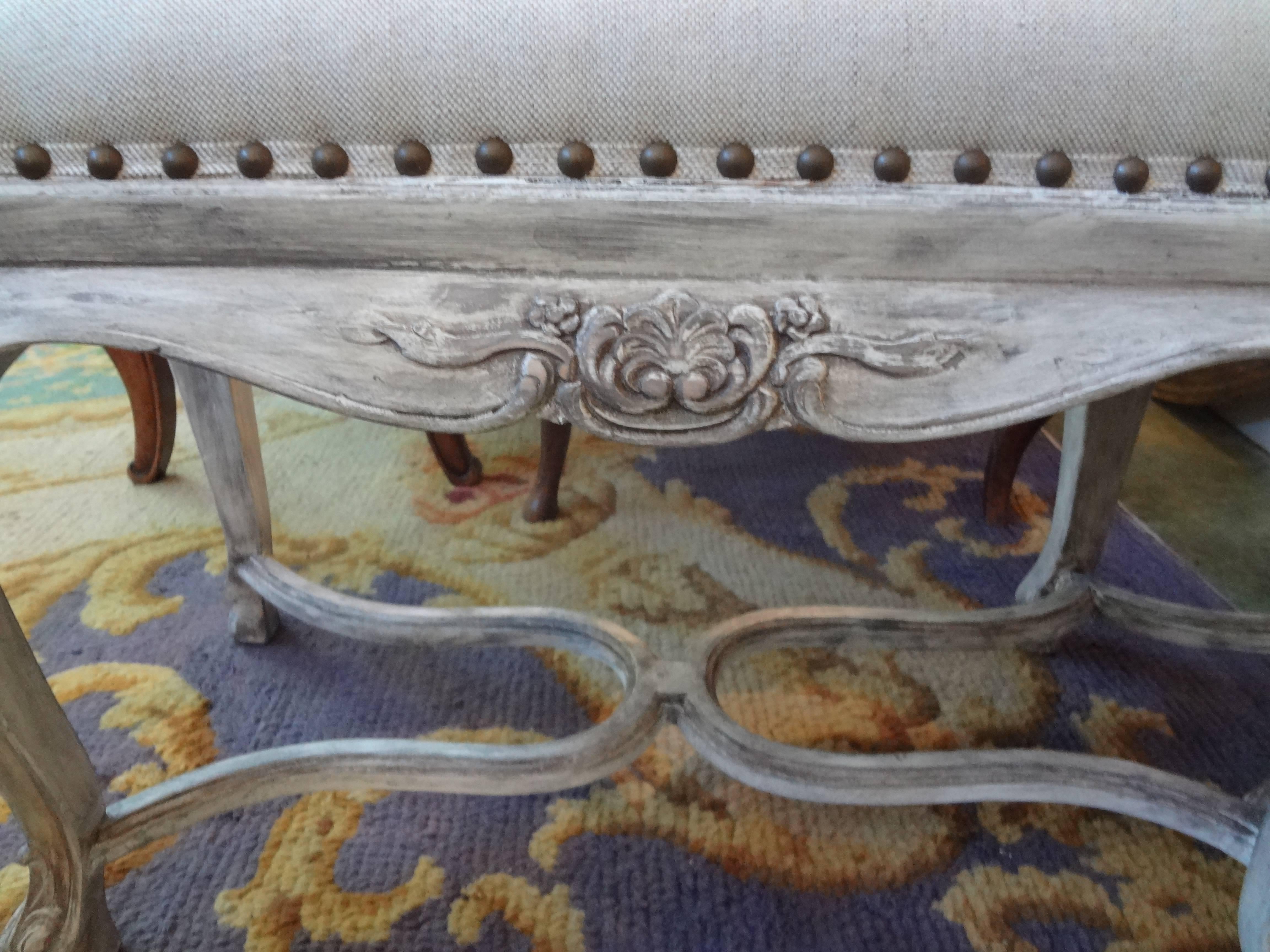 Versatile French Louis XIV style painted bench newly upholstered in oatmeal linen with brass spaced nailhead trim, circa 1920.

Please click KIRBY ANTIQUES logo below to view additional pieces from our vast inventory.
 