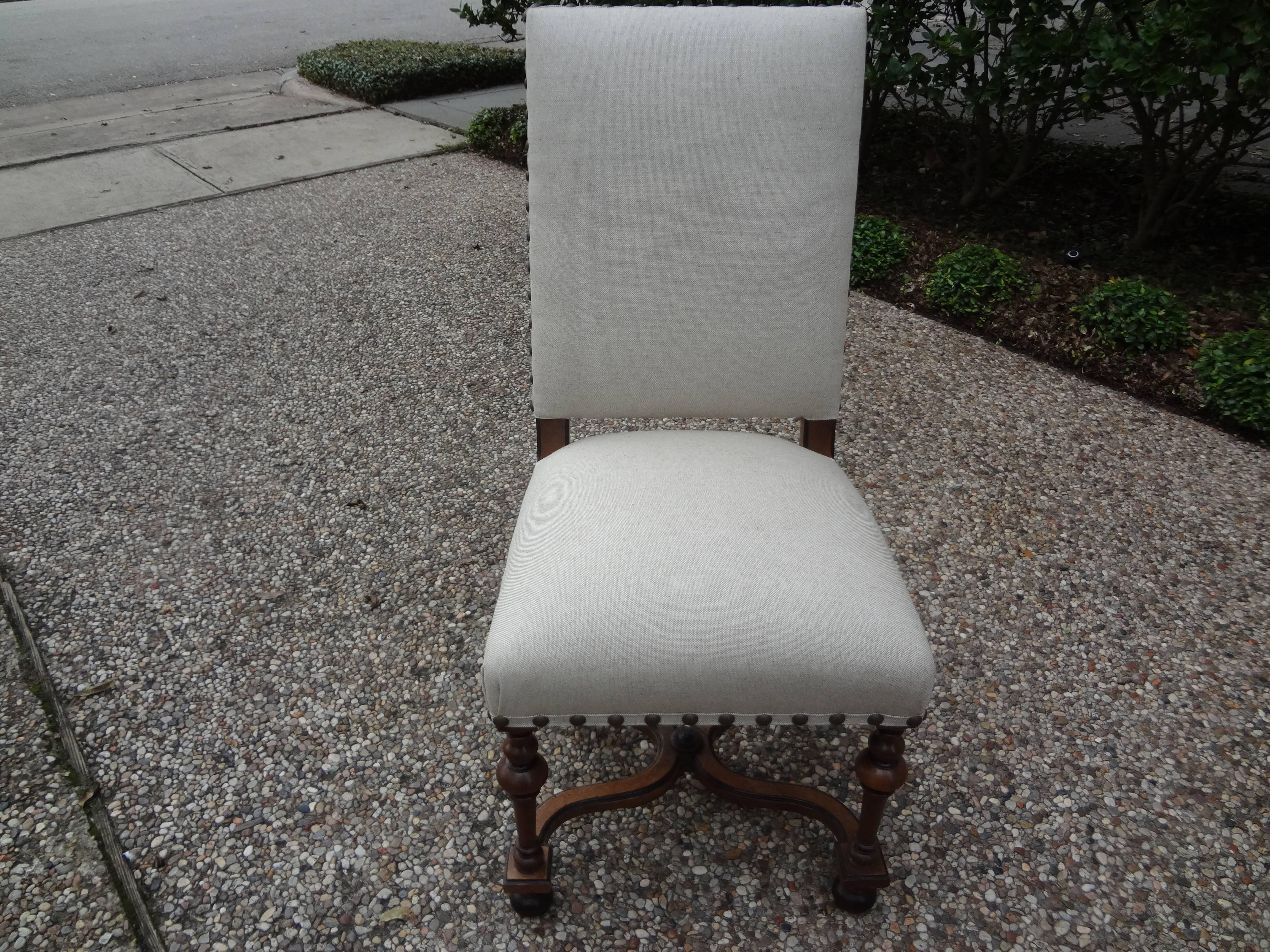 Well made 19th century French Louis XIV style walnut dining chairs newly upholstered in oatmeal linen with French brass spaced nailhead detail.

Please click KIRBY ANTIQUES logo below to view additional pieces from our vast inventory.

