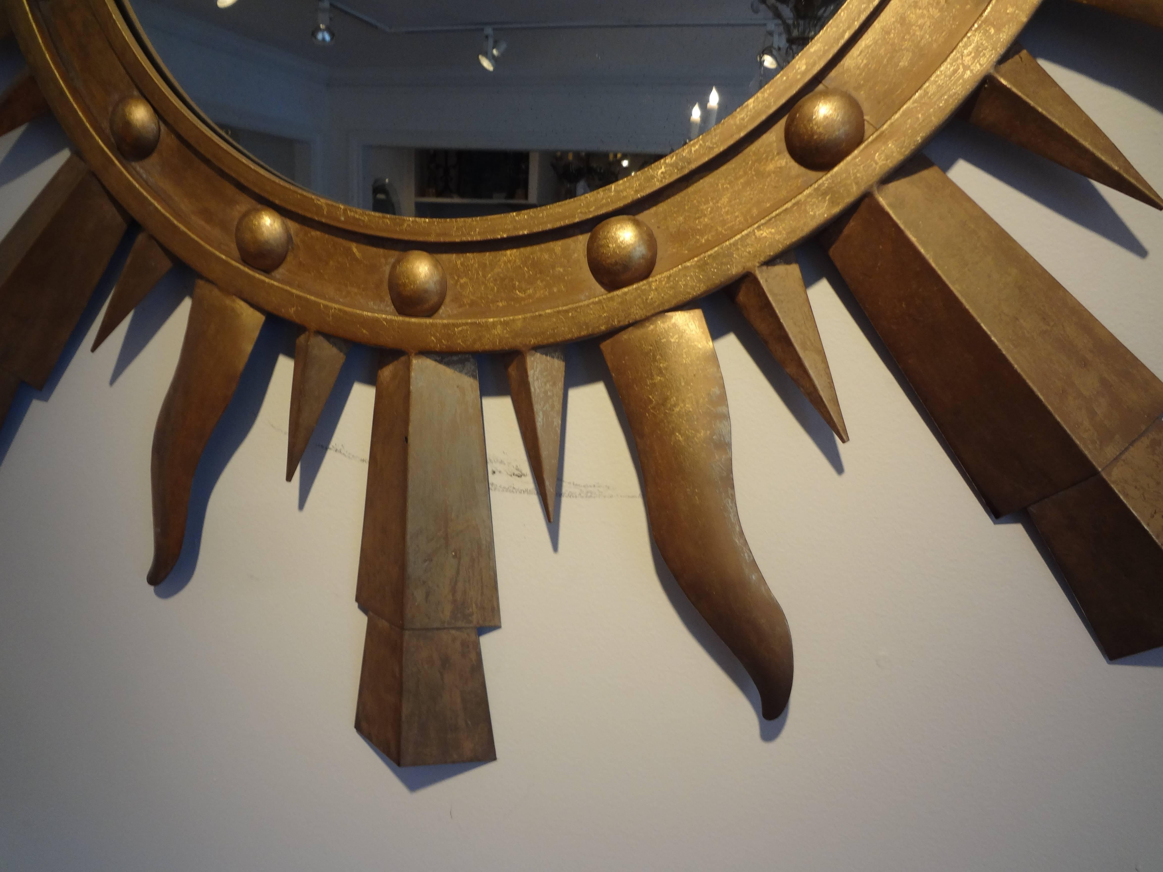 Large midcentury Italian gilt iron sunburst mirror, Gilbert Poillerat style.
Large vintage Italian gilt iron Gilbert Poillerat style sunburst mirror. This iconic Italian starburst mirror measures: 47.25 in diameter. Great patina!

