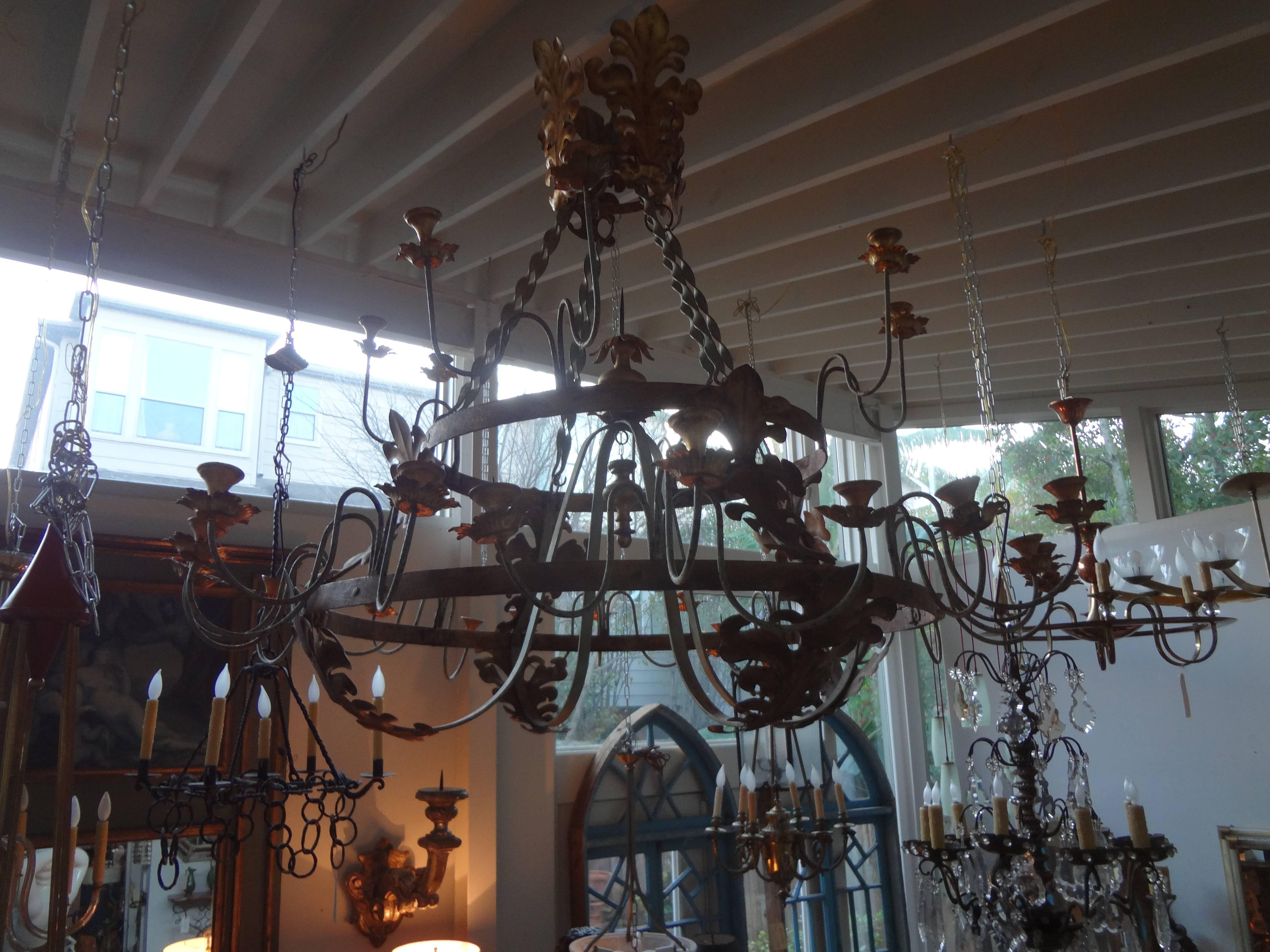 Stunning Italian hand-forged gilt wrought iron, tole and gilt wood thirty-two-light chandelier from Tuscany.  Measures: 60 inches H  72 inches  D.

 
  