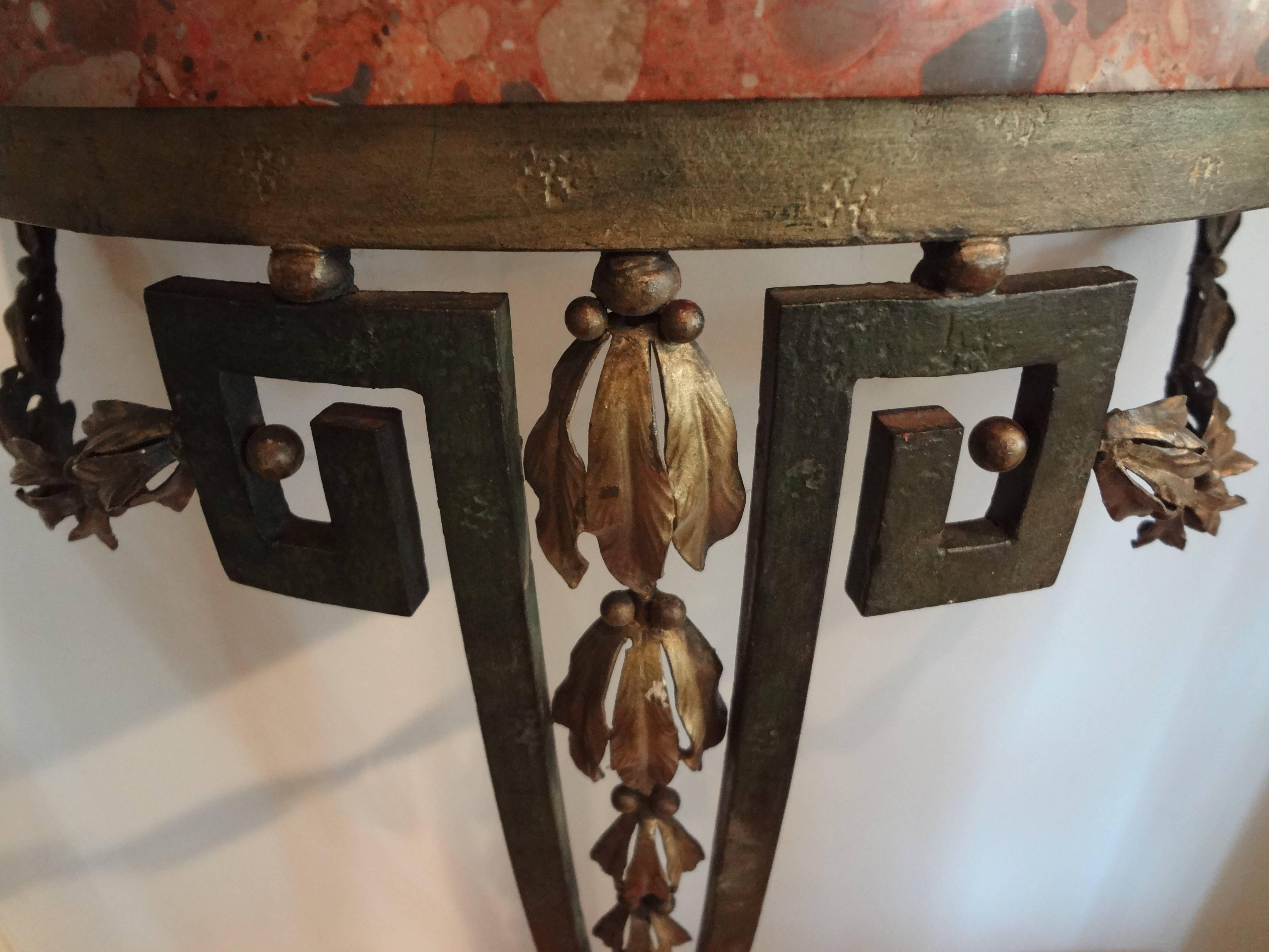Lovely antique French Louis XVI style or neoclassical style hand-forged wrought iron console table with gilt accents and Greek key design with gorgeous original marble top.
Easily fastened to the wall with three screws.

 