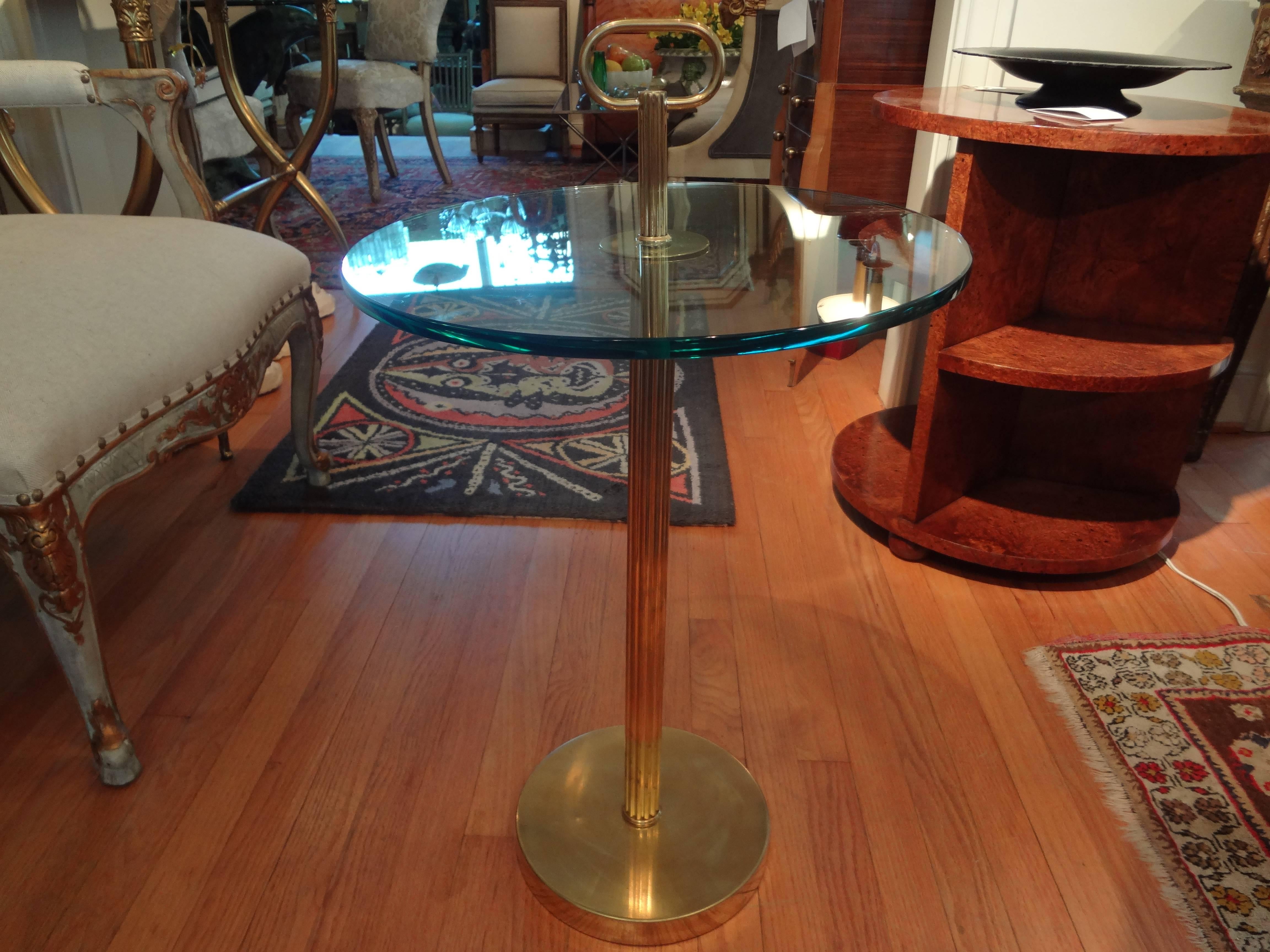 Chic pair of Mid-Century Modern Italian brass cigarette tables / gueridons with handles, after Gio Ponti, circa 1970.

Please click KIRBY ANTIQUES logo below to view additional pieces from our vast inventory.