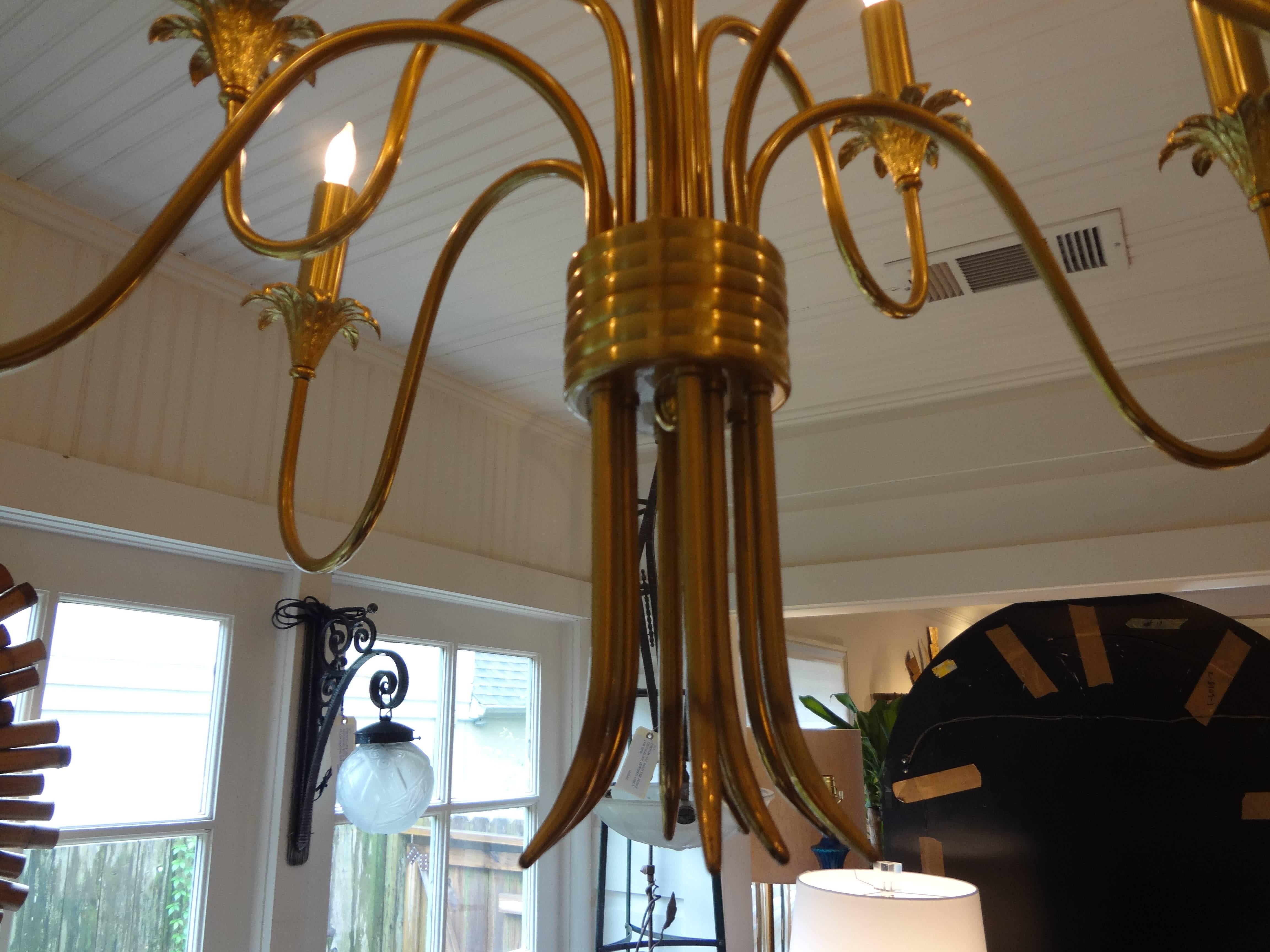 Chic Italian Stilnovo style nine-arm brass chandelier, newly wired for U.S. market, circa 1960. This stylish Italian midcentury brass chandelier comes with a 36