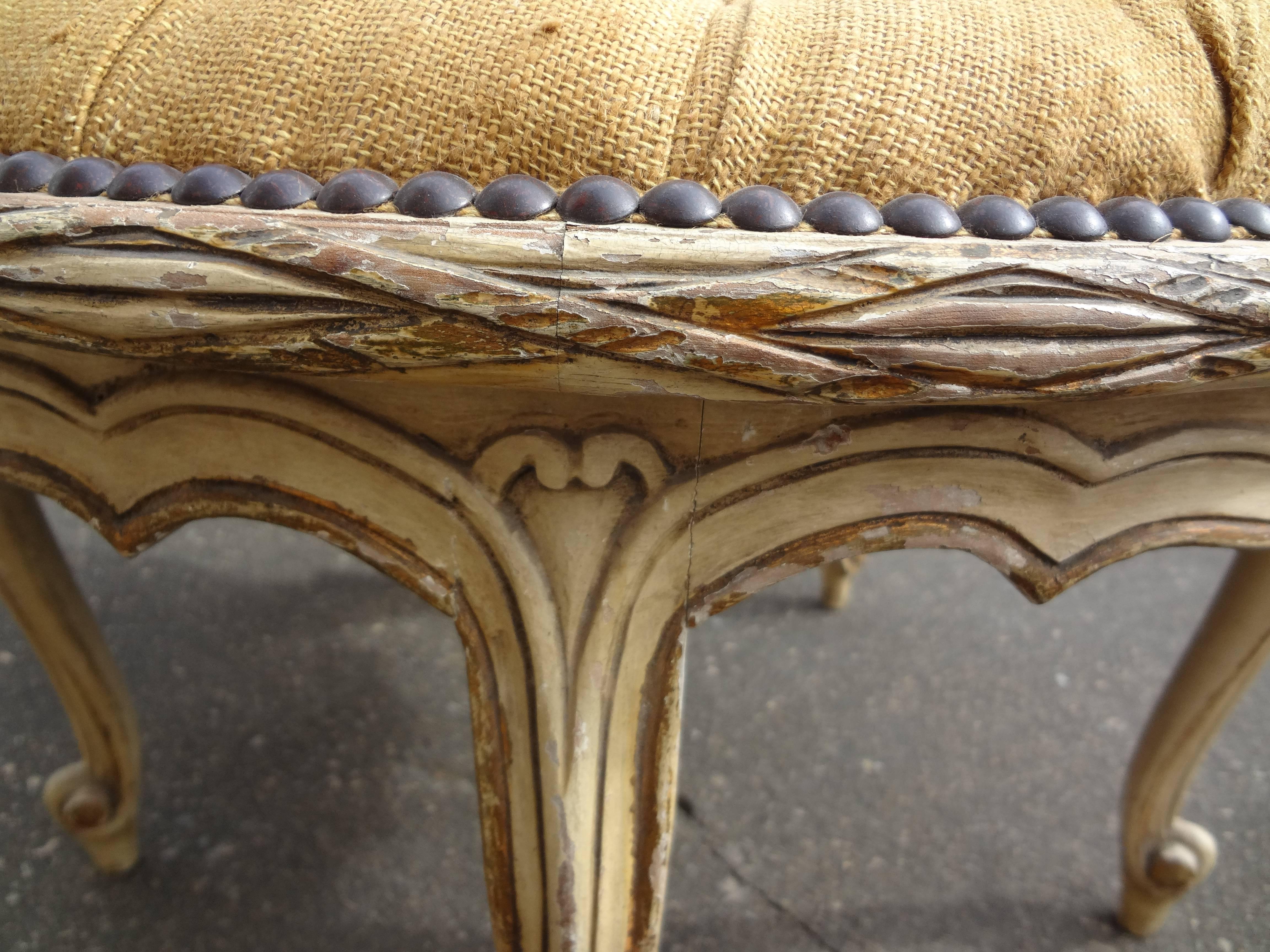 Beautiful French Louis XVI style painted and giltwood stool or poof with five legs, newly upholstered button tufted seat in burlap with brass nailhead trim.