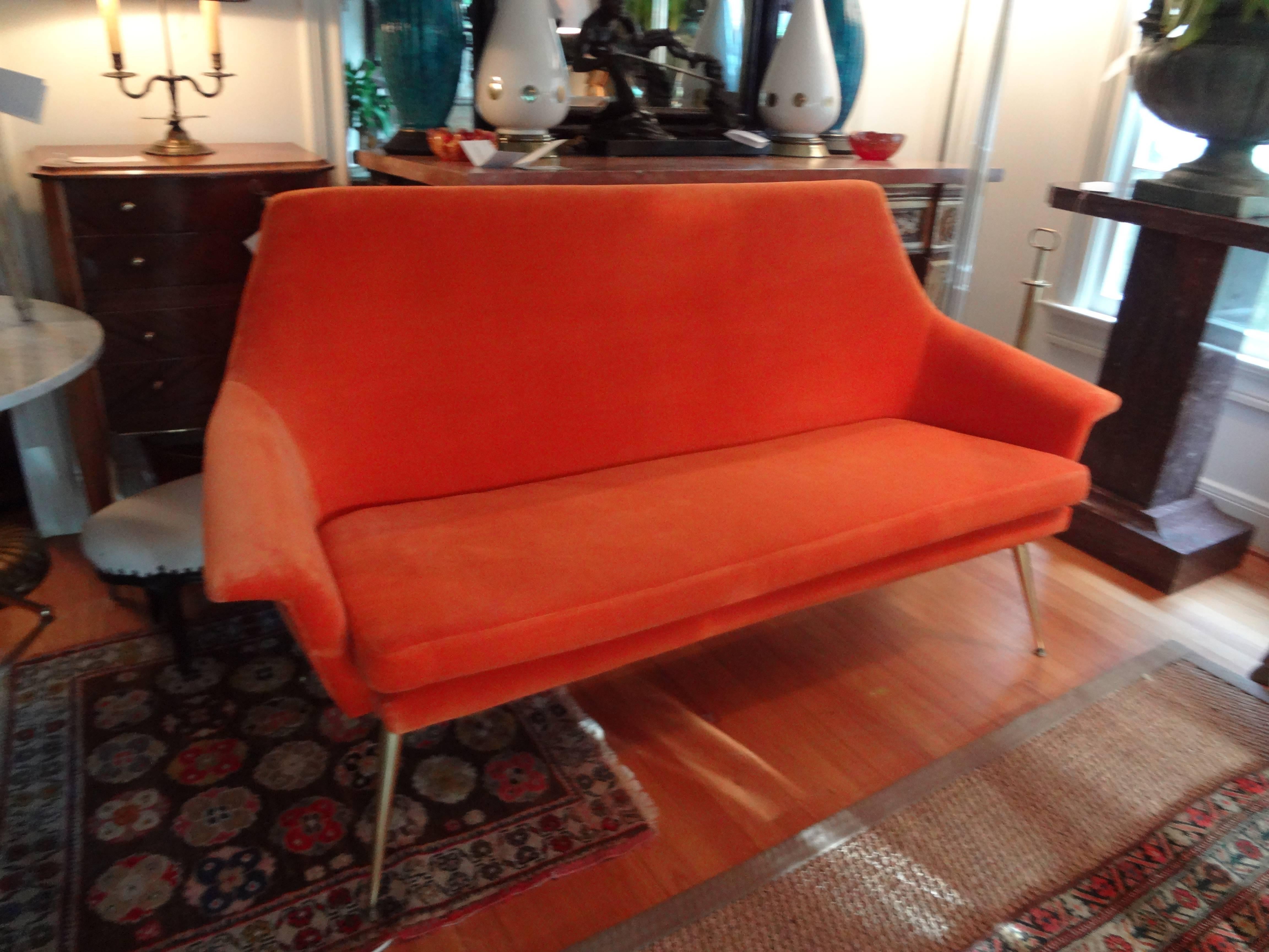 Stylish and comfortable Italian Mid-Century Modern Gio Ponti inspired sofa or canape with brass splayed legs upholstered in orange velvet.
The form is similar to works by artists of the same era in Italy, such as Carlo Mollino , Campo Graffi, Ico