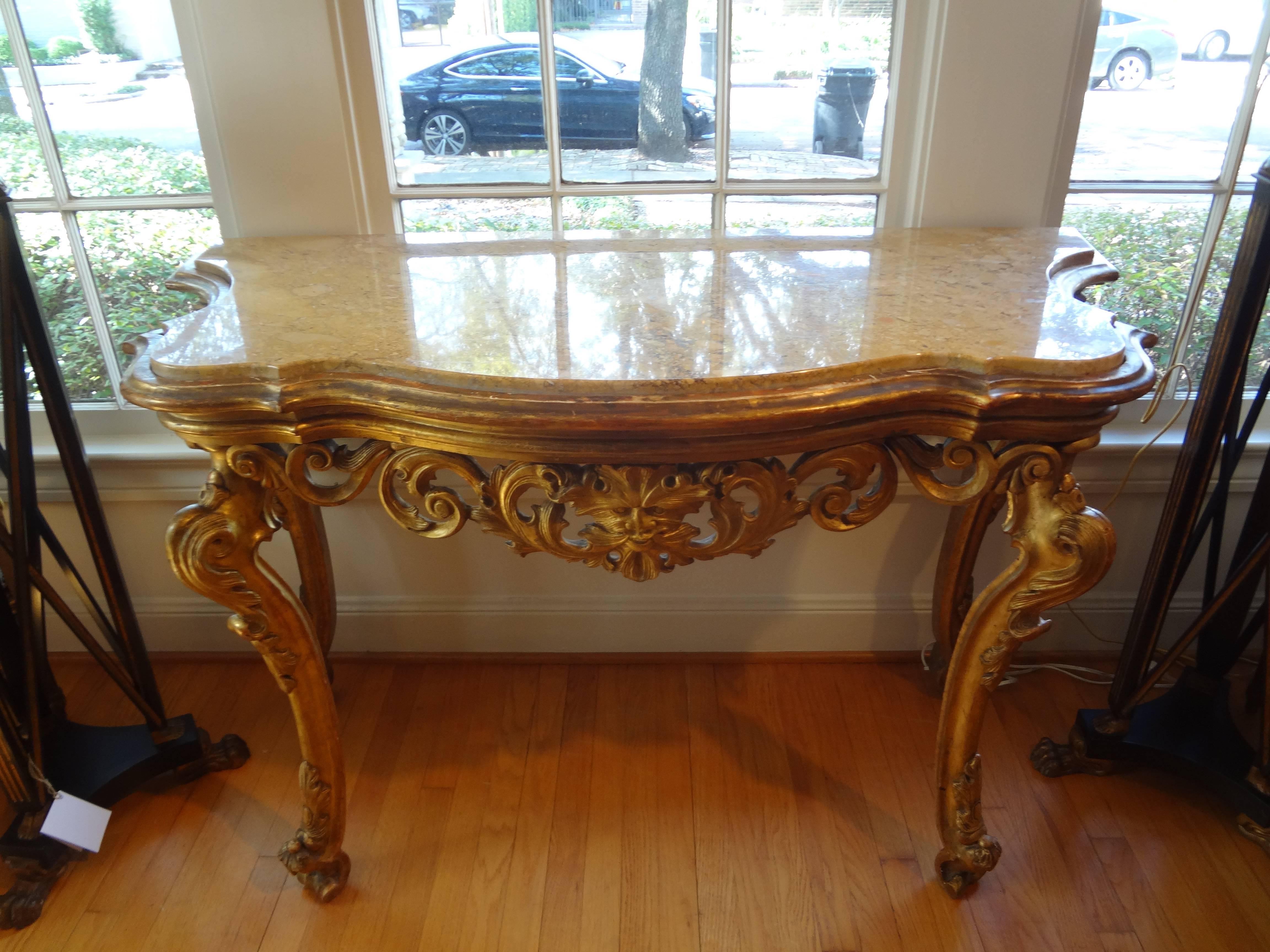 18th century Venetian giltwood console table with marble top.
Gorgeous antique Italian Louis XIV freestanding gilt wood console table from Venice with original marble top.
This fabulous antique Italian gilt console or demilune has a central mask