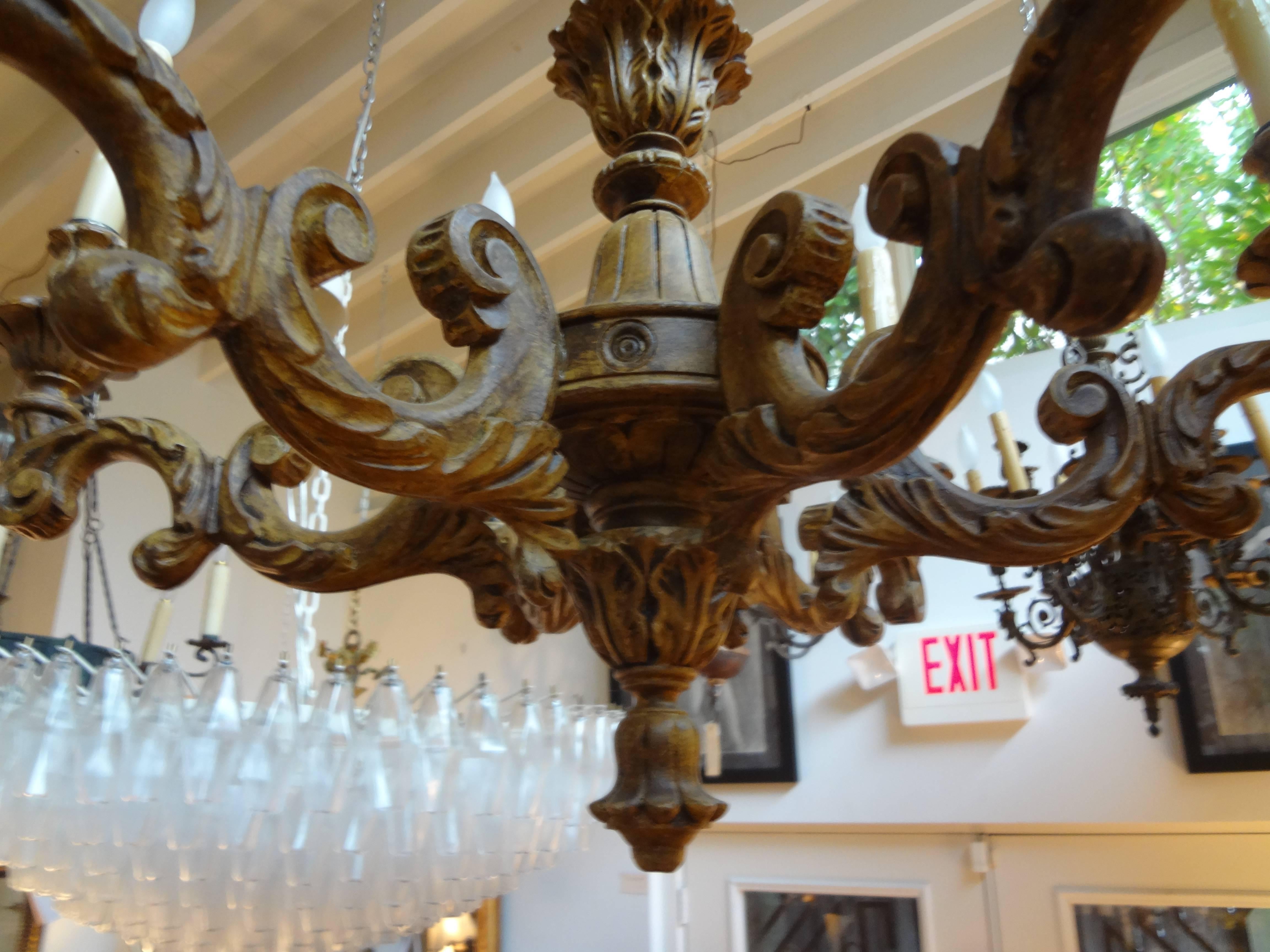 Italian Genovese six-arm patinated wood chandelier. This gorgeous hand carved Italian chandelier has been newly wired to U.S. specifications and dates to the 1920s.
