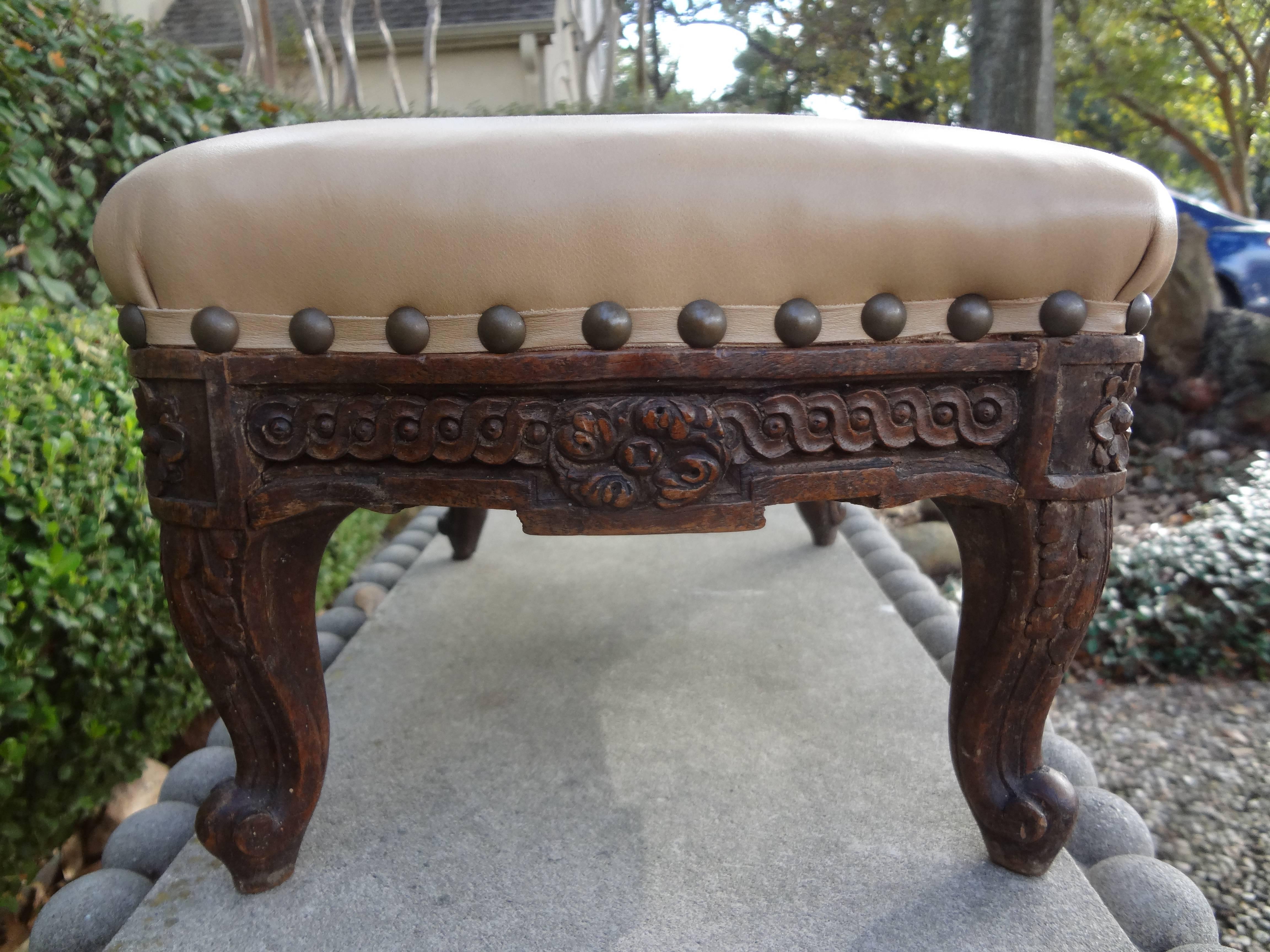 Well carved 19th century French Louis XV-XVI style foot stool or ottoman/tabouret. Newly upholstered in leather with spaced brass nail head detail. Great table top piece to display a prized possession!