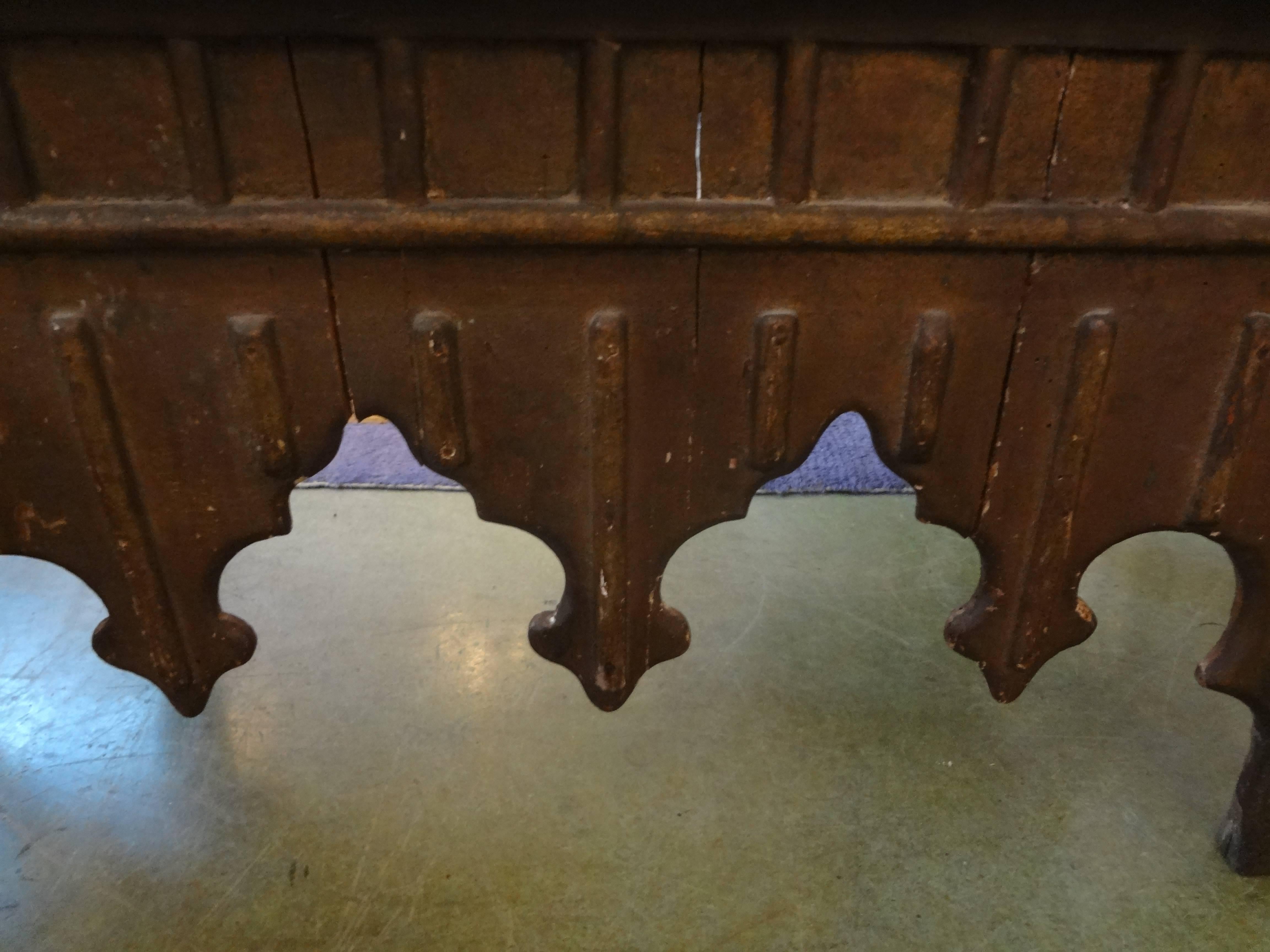 Antique Moroccan Bench with Moorish design newly upholstered in oatmeal linen with brass nailhead detail.