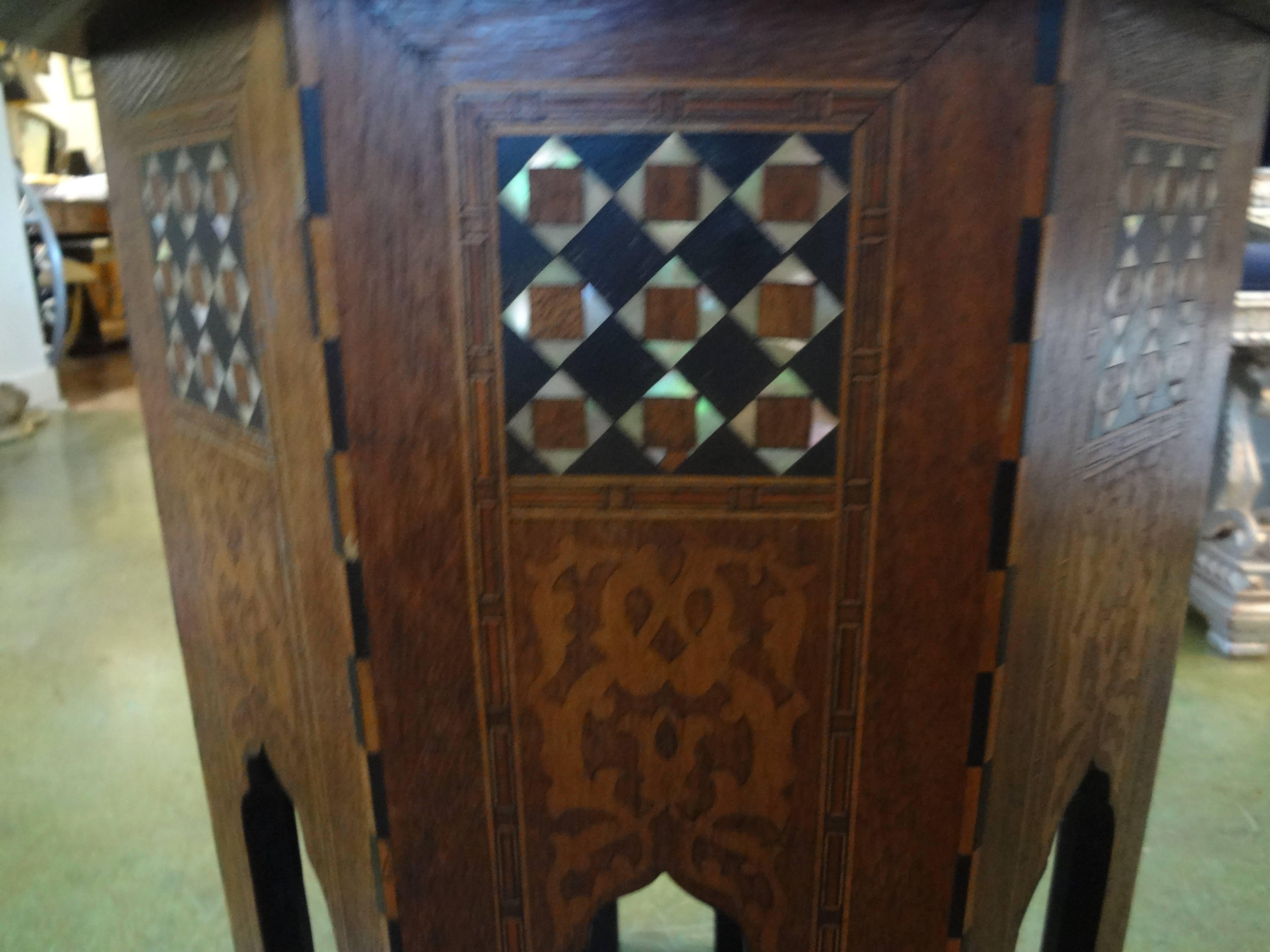 Versatile Moroccan, Syrian or Middle Eastern octagon side table intricately inlaid with mixed woods and mother-of-pearl in a geometric pattern.