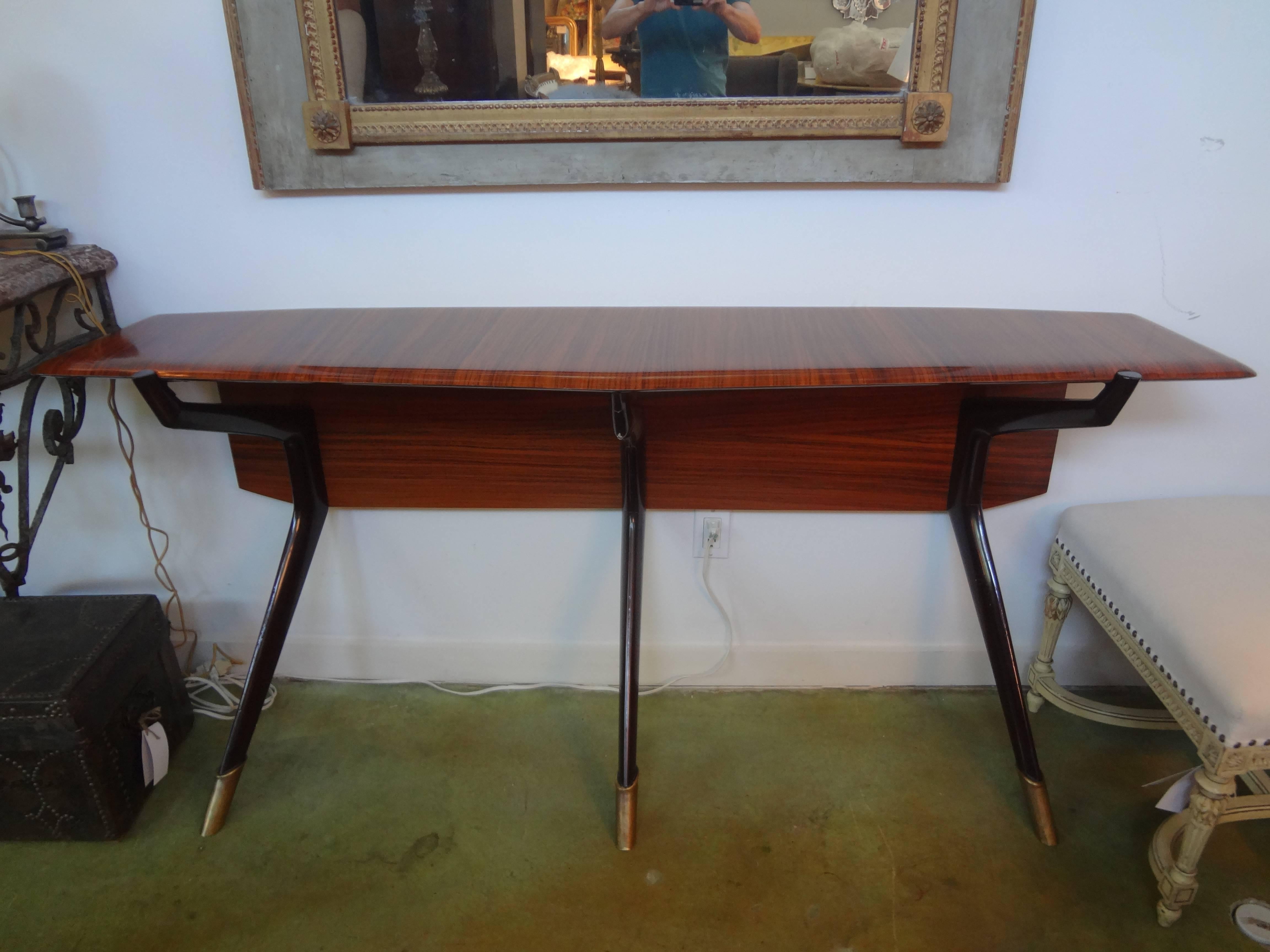 Italian console table in the style of Ico Parisi, Milan, with three legs terminating in bronze sabots, circa 1950. This outstanding Italian Mid-Century Modern console table is wall-mounted and gorgeous from every angle.