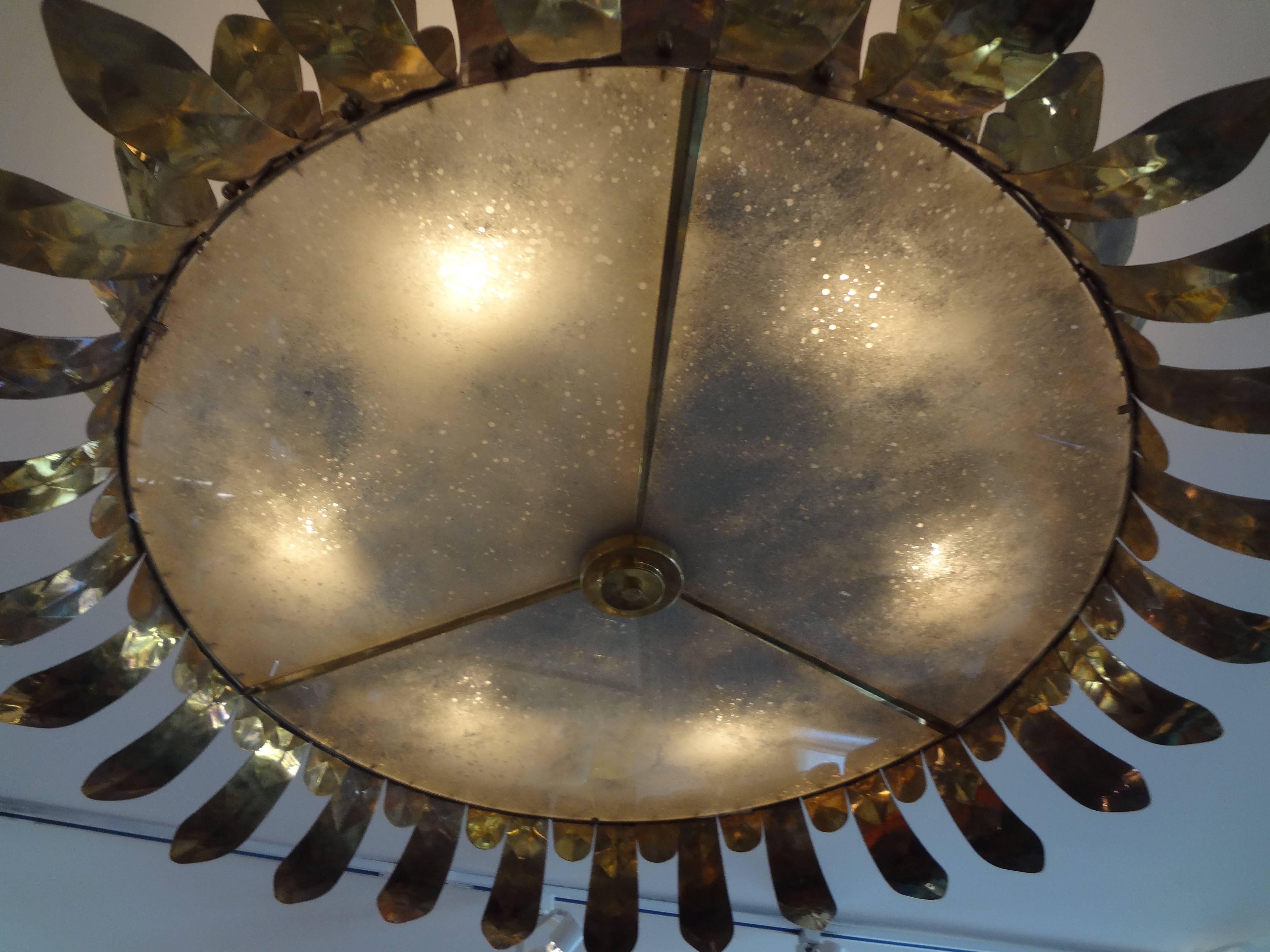 Large Italian Mid-Century Modern Art Deco style hand-hammered brass and glass chandelier that can be flush mounted or hung from a chain at any height 40 inches in diameter. Newly wired for U.S. Market.
36 inch heavy duty brass chain included.