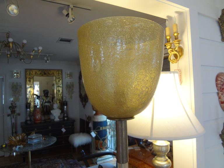 Murano Glass Floor Lamp by Seguso, circa 1940.
Stunning Murano floor lamp by Seguso, circa 1940. Gold infused glass with a pulegoso up light shade trimmed in bronze. Overall dimensions of our Murano glass torchère are 68.75 inches height, 16 inch