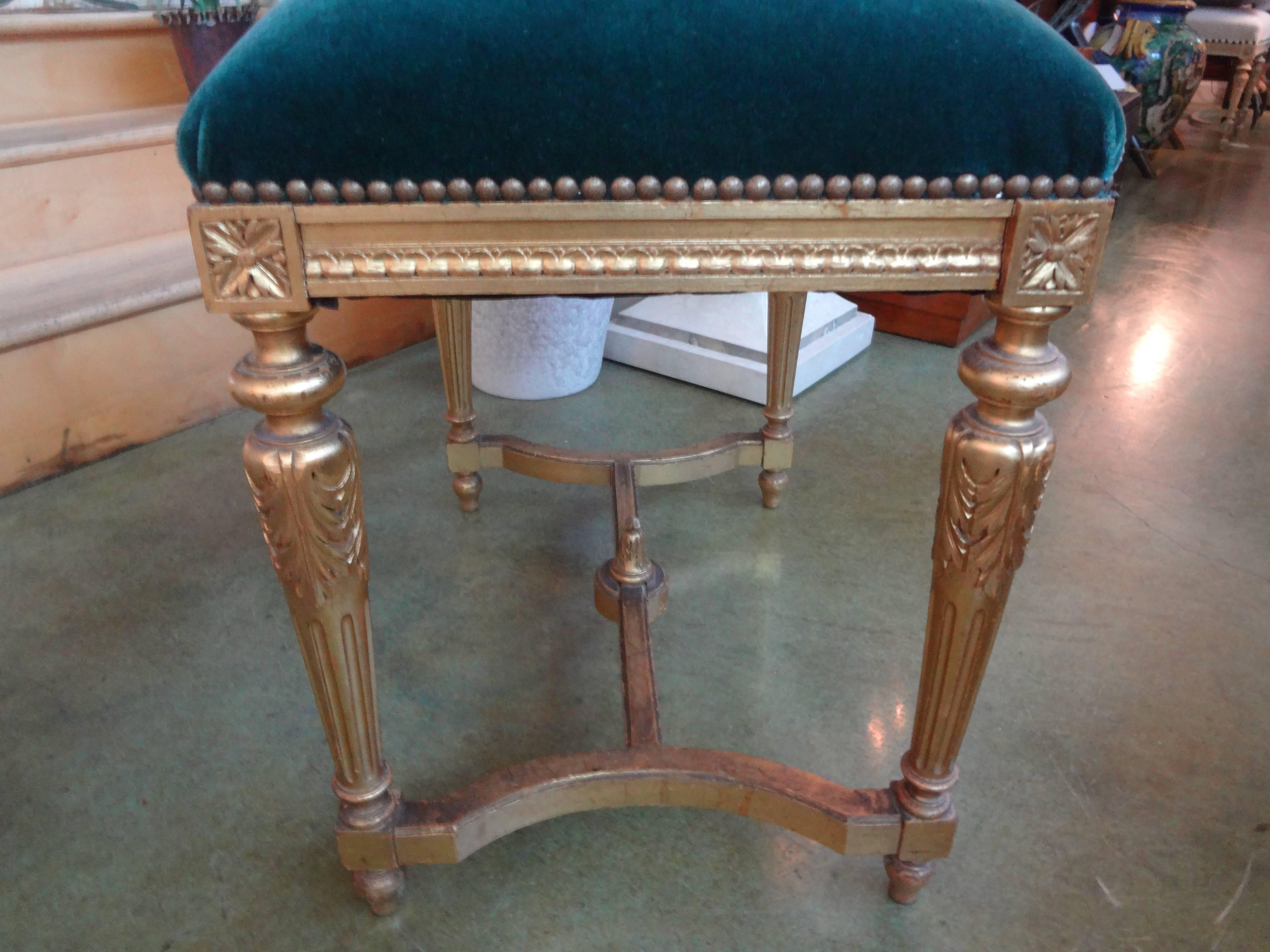 Antique French Louis XVI style giltwood bench or stool newly upholstered In teal mohair with brass nailhead detail.