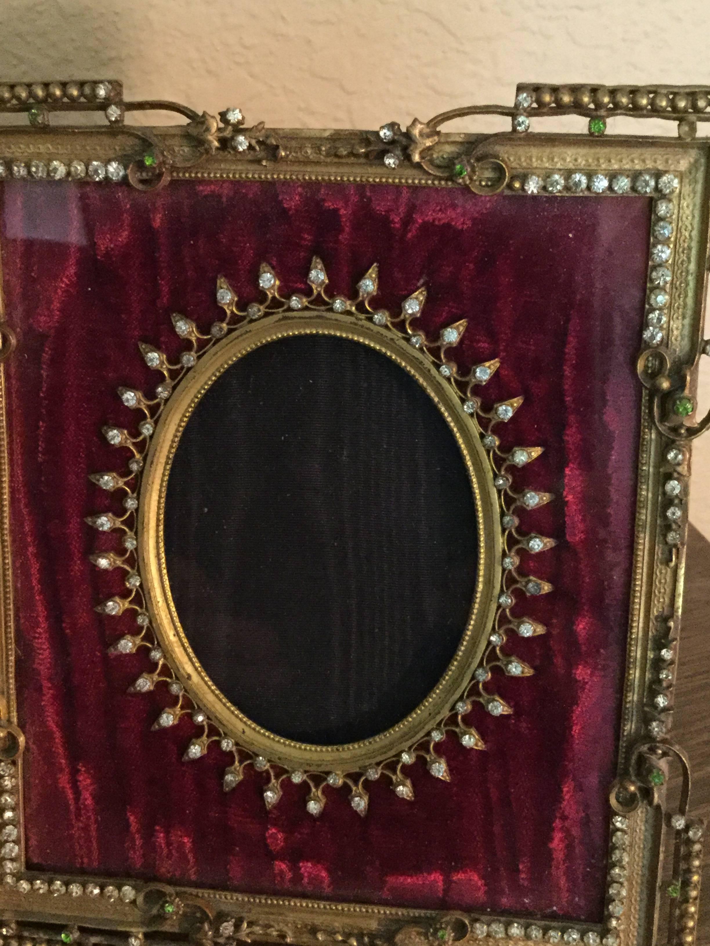 Fabulous antique French, Louis XVI style bronze/brass photograph or picture frame with approximately 118 paste jewels on the exterior and 36 larger stones on the inside oval circle with 34 smaller stones that loop the larger ones together. The