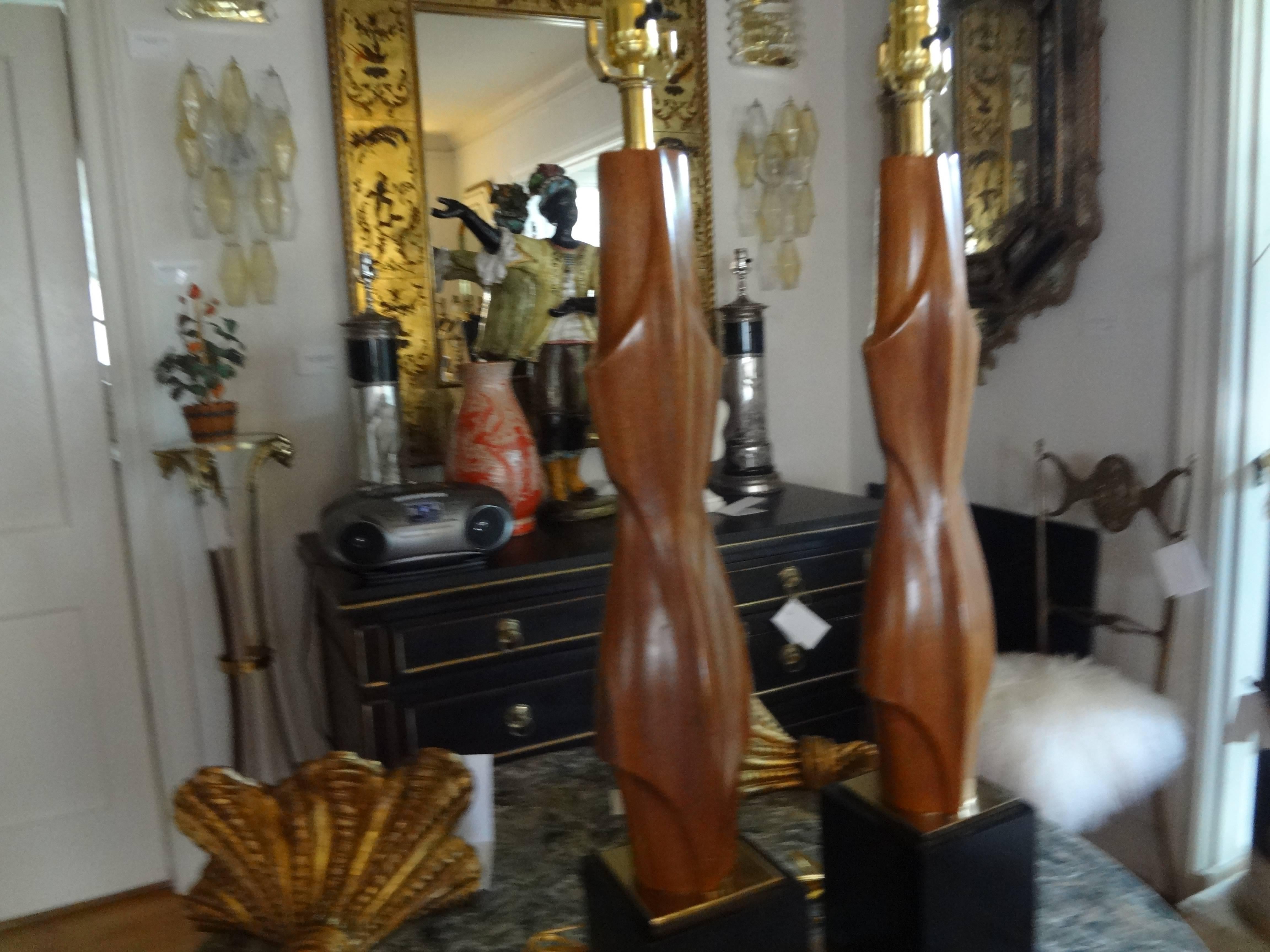 Stylish pair of Mid-Century Modern carved wood lamps on patinated brass bases by Maurizio Tempestini. Newly wired.