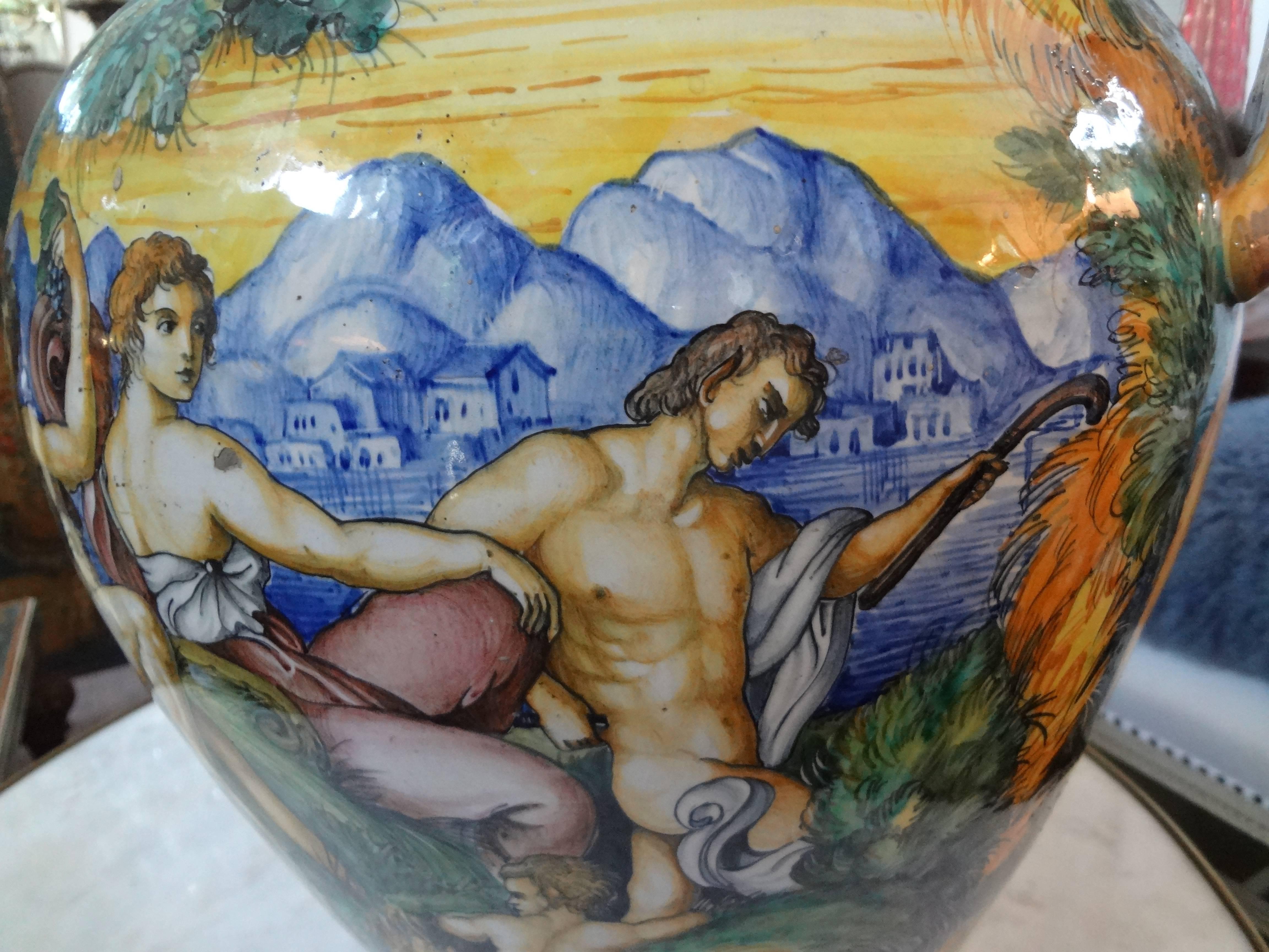 Beautifully hand decorated large Italian Maiolica or Majolica glazed earthenware urn or vessel with colorful mythological scenes attributed to Urbino Workshop. This piece dates to the mid-19th century. Some chips to the glaze on body of structure,