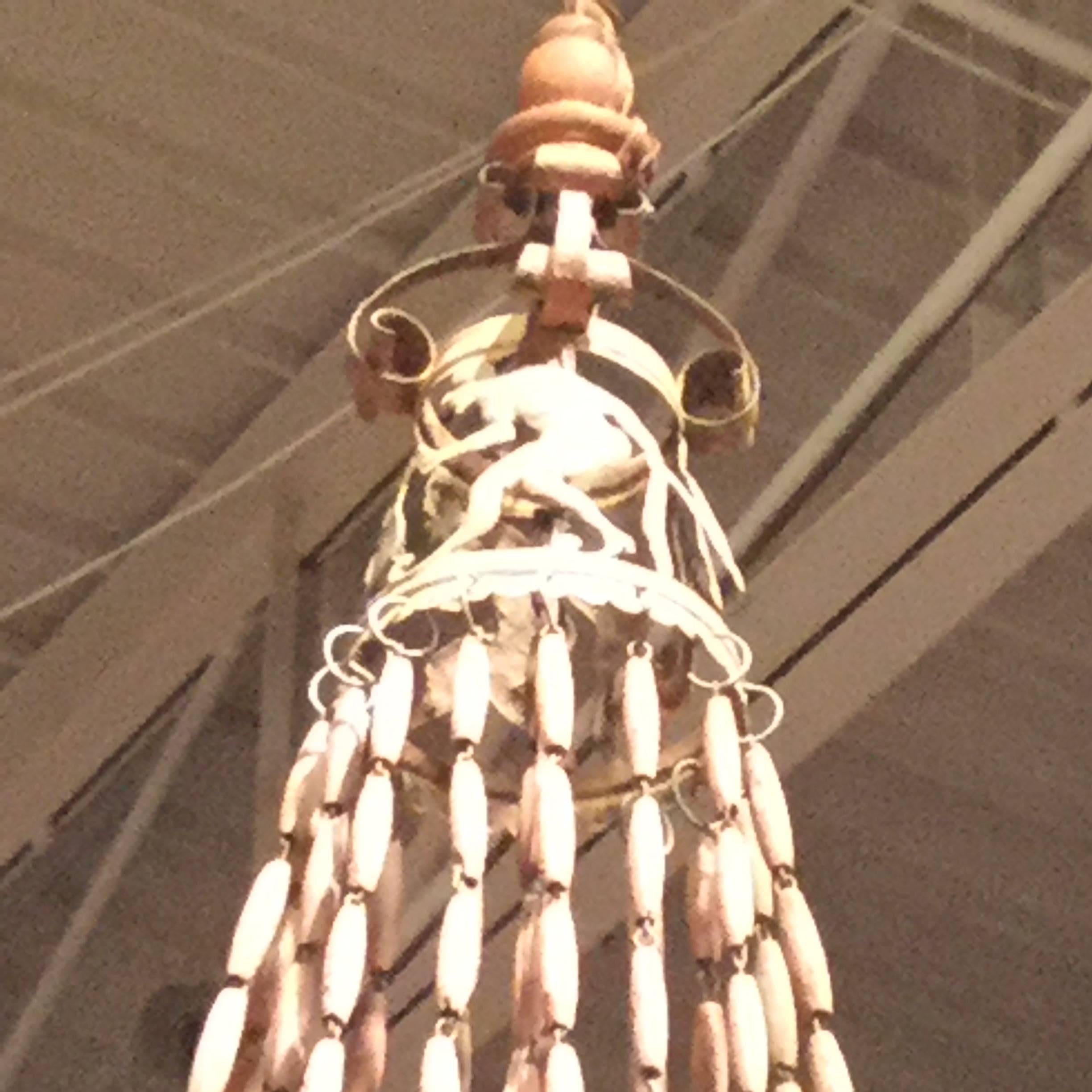 A large four-light Italian wooden beaded chandelier in a light a terracotta color with ornate candleholders that has been newly wired. This is easily shortened around the top if desired. Iron with wooden beads.




