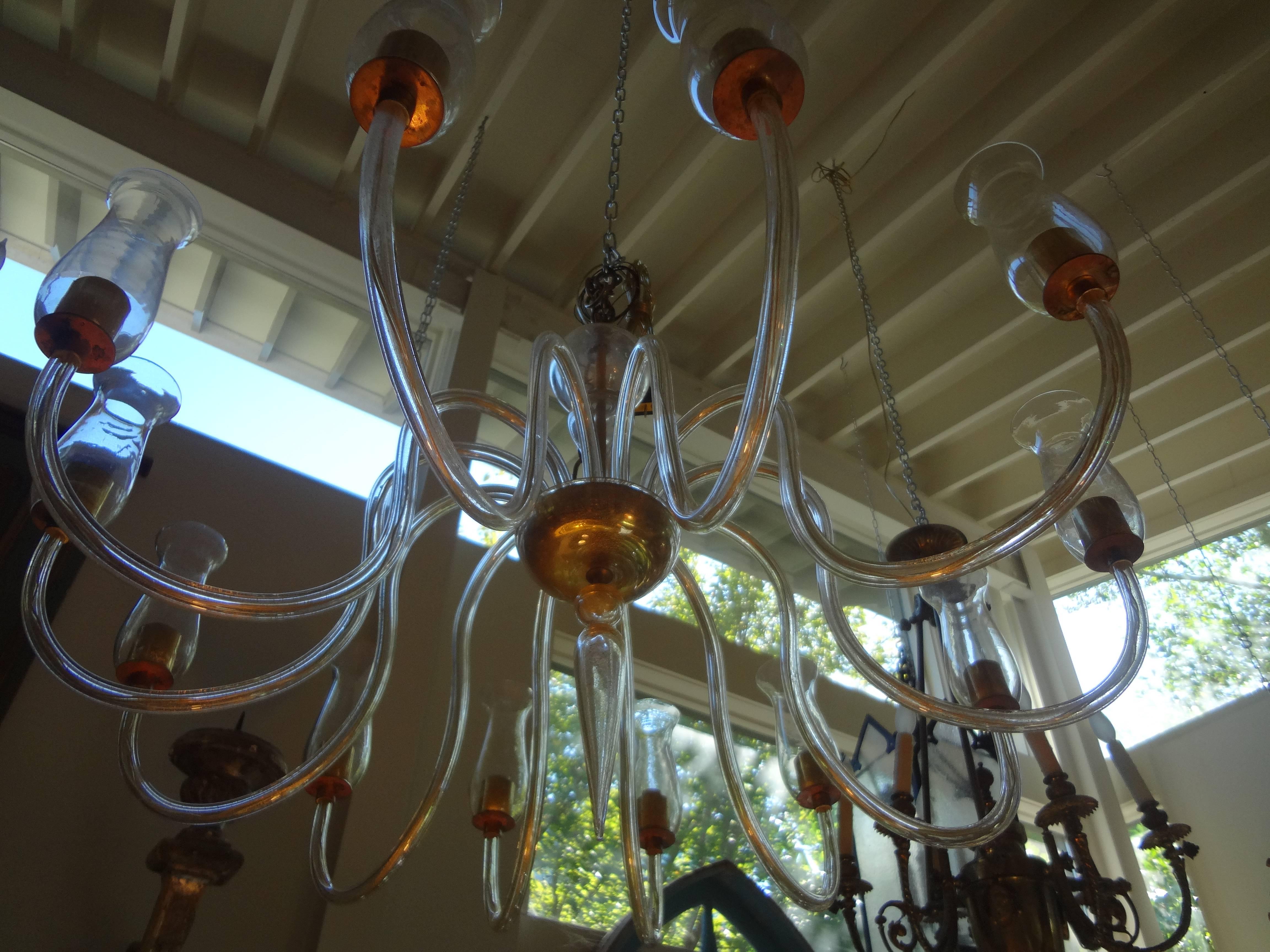 Stunning Venetian Barovier inspired twelve-light chandelier of clear handblown glass infused with gold. Each branch holds a beautifully shaped shade sitting on a brass fitting. This classic 1940s, Italian chandelier has been newly wired for the U.S.