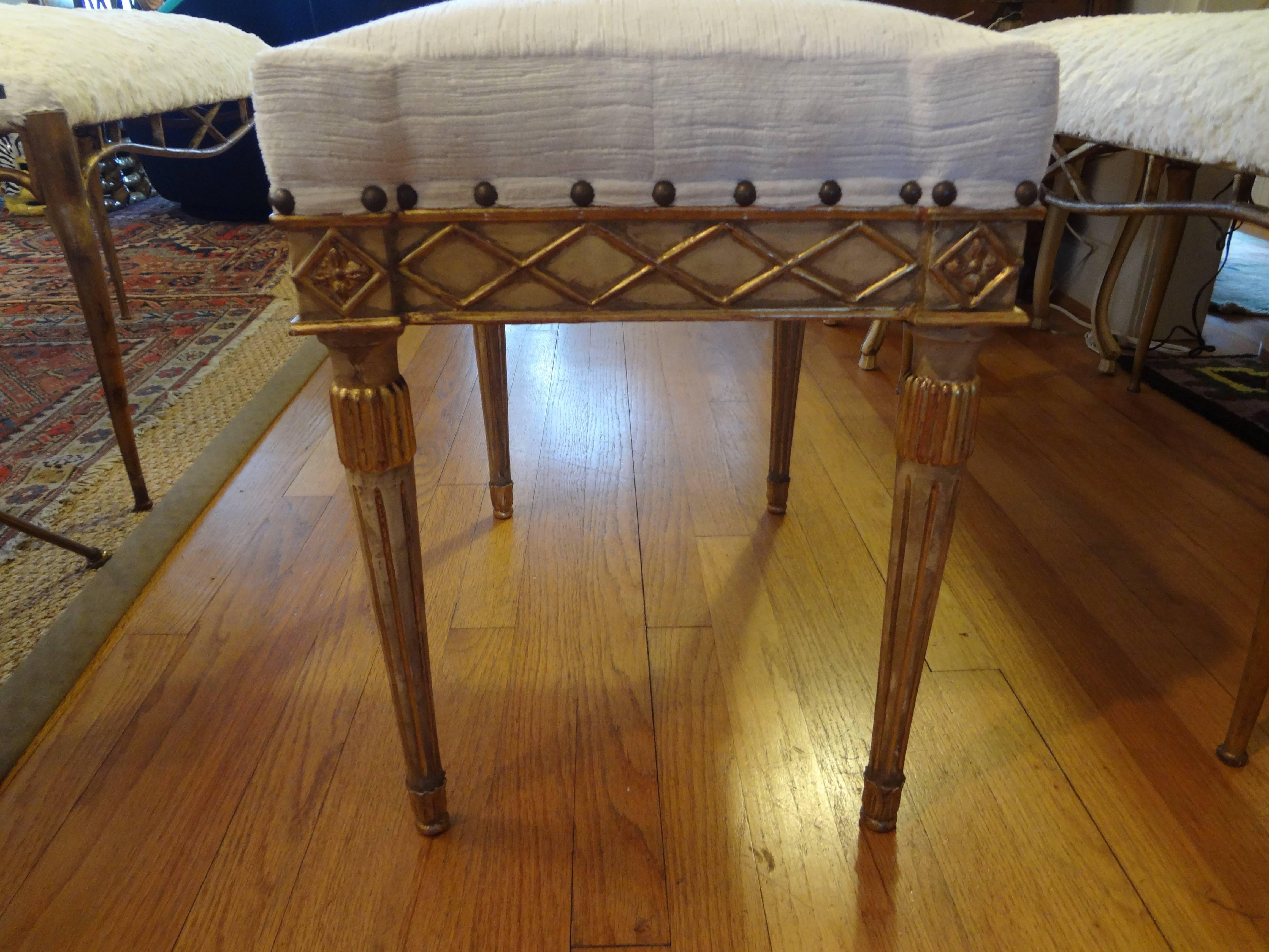 Pair of 19th century Italian giltwood benches or ottomans.
Lovely pair of antique Italian Louis XVI style painted and giltwood benches, stools or ottomans taken down to frames and professionally reupholstered in cream striated velvet. These