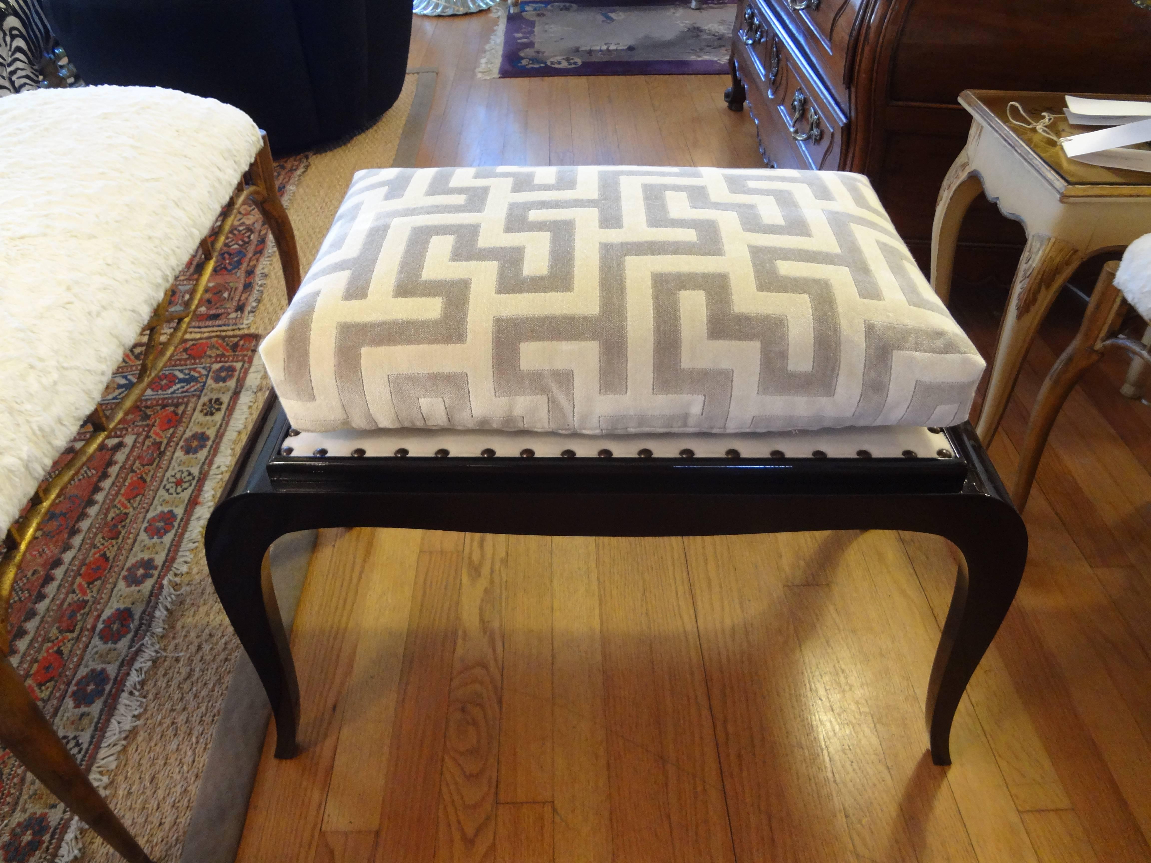 Period French Art Deco bench, stool or ottoman with black lacquered finish professionally upholstered in Greek key cut velvet fabric, circa 1930. This French Art Deco Ruhlmann inspired bench would work well in a black and white interior.