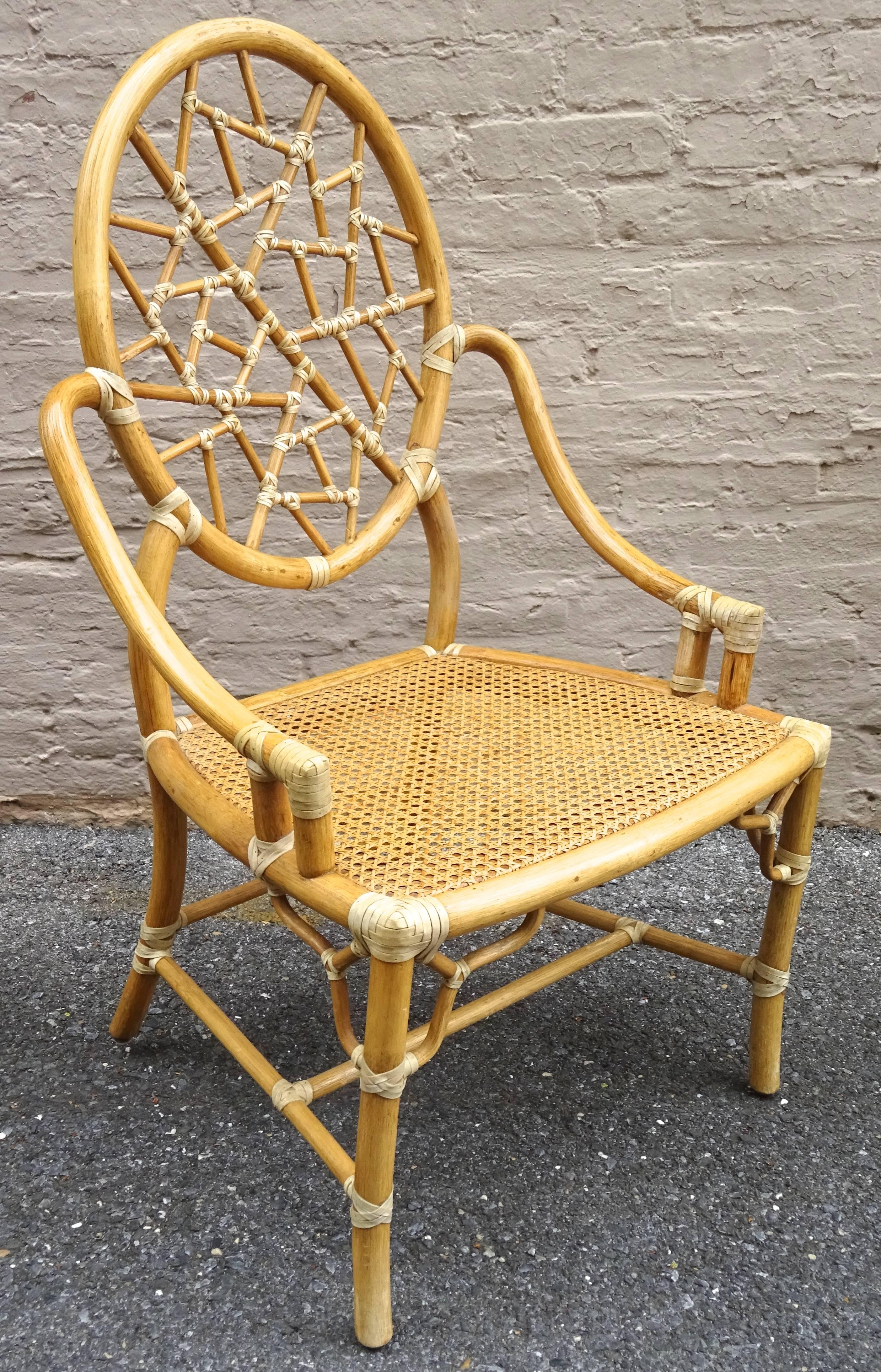 Chic set of four of 1970s McGuire chinoiserie wrapped rattan dining chairs.