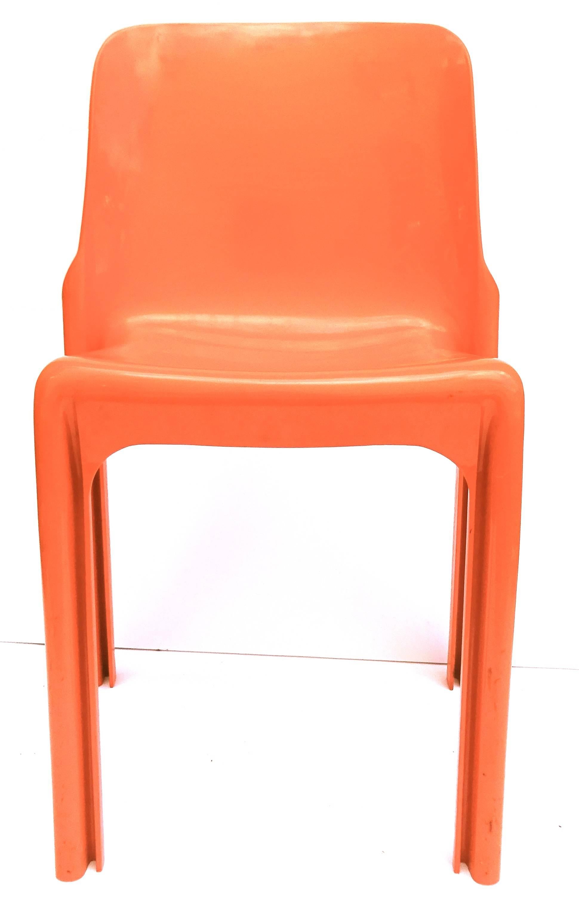Fun and fabulous set of four Vico Magistretti dining chairs. Italy, c. 1970.  This is his Selene chair model, made for famed manufacturer Artemide.  They are in a great bright orange color way.  We also have the matching square dining table which