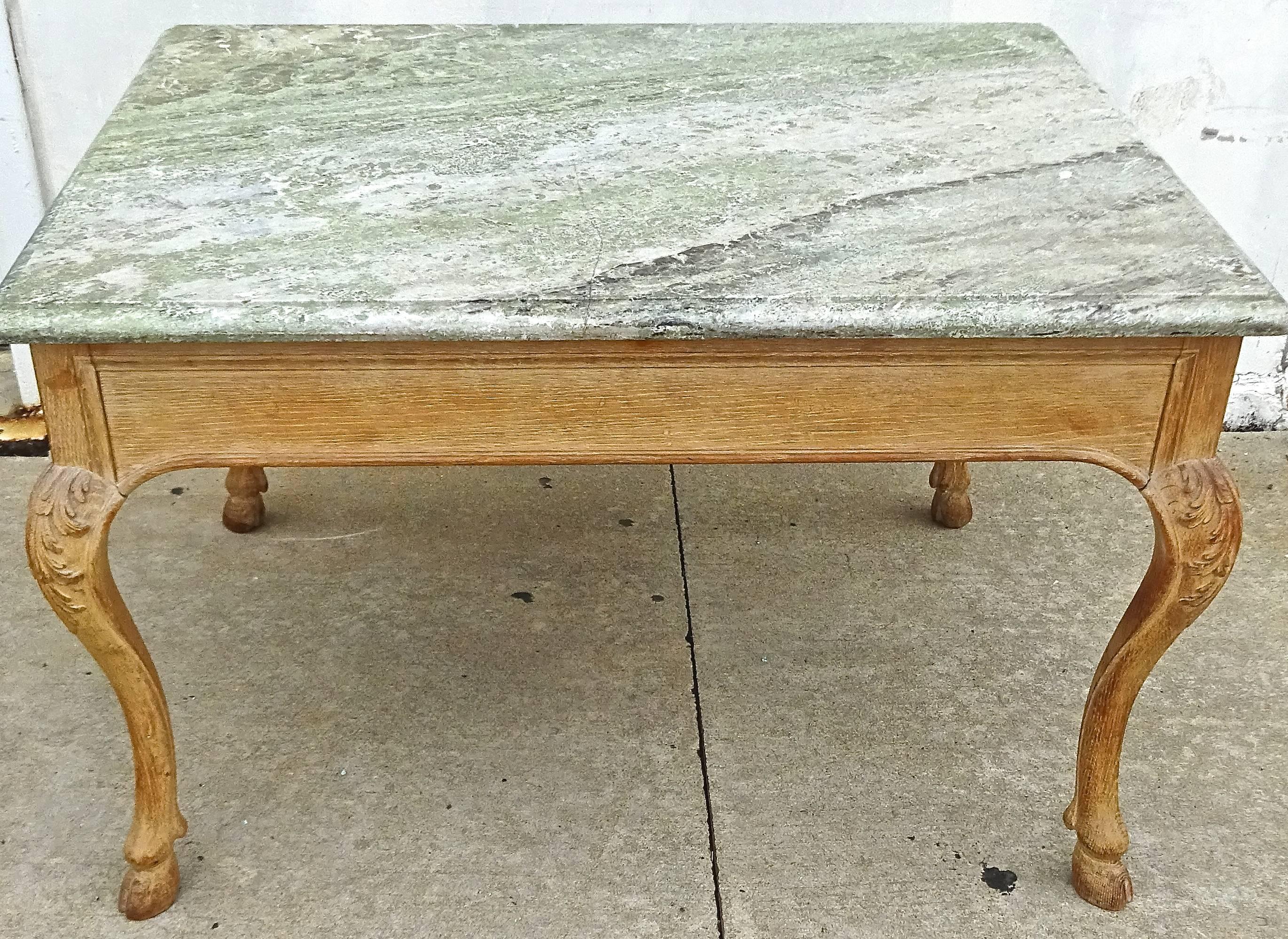 Marvellously chic late 19th century French center or library table with rare thick green specimen marble top. Oak has a unique dry bleached finish with wonderful patina. This table would work well as a centre table, but could also be used as a desk