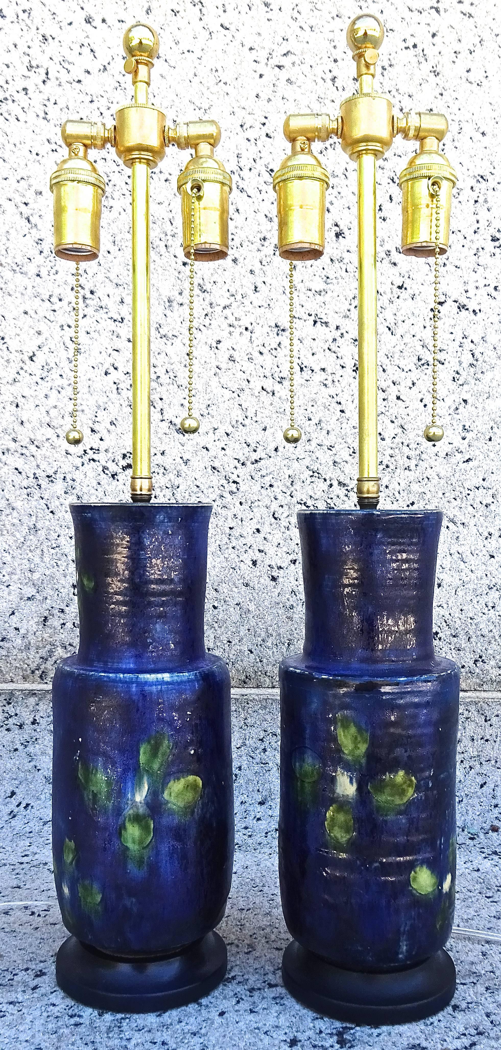 Charming pair of vibrant blue art pottery table lamps, 1950s French. Pottery vases are hand thrown and decorated, and fitted with new brass double socket hardware.