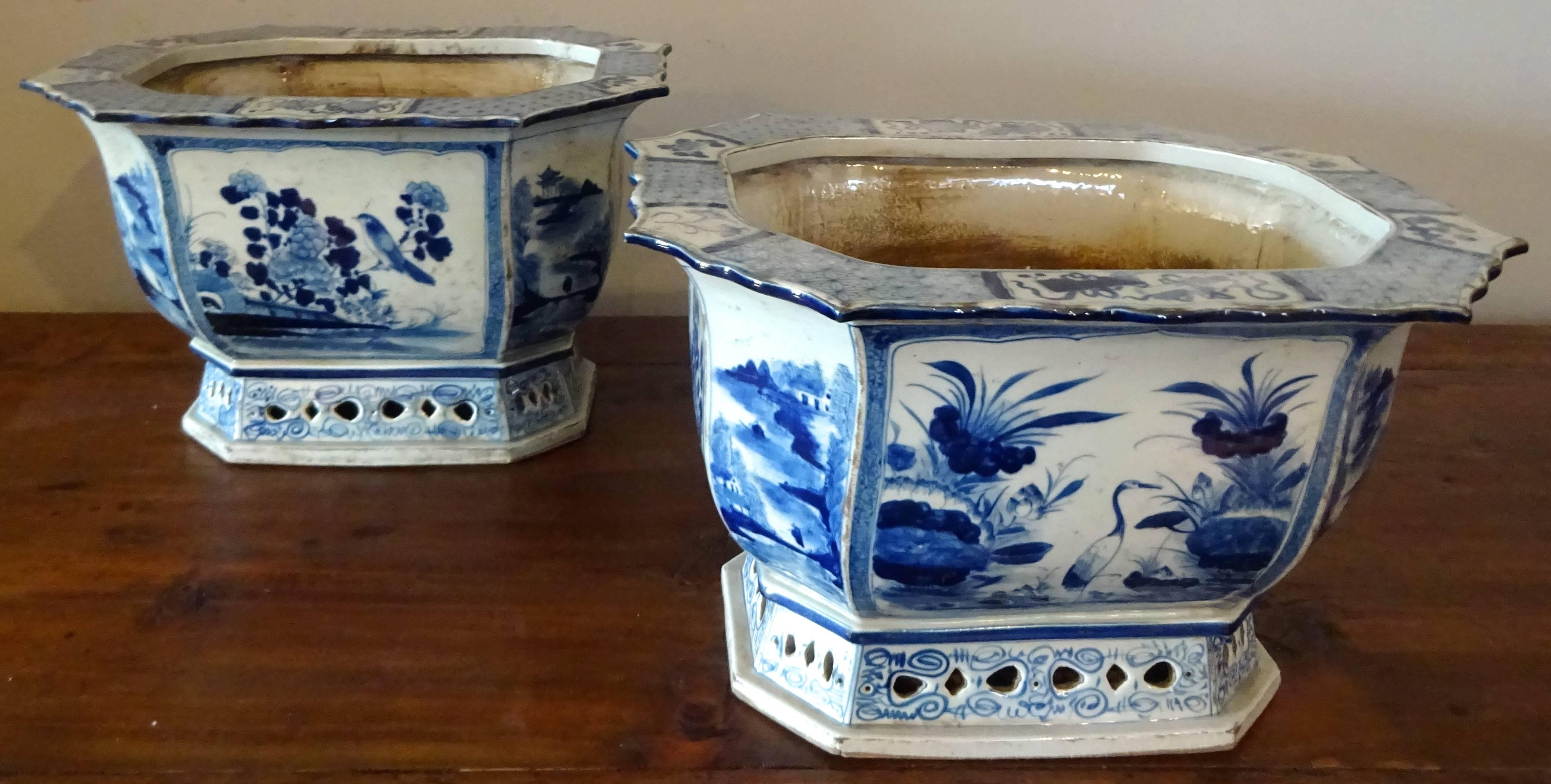 Exquisite pair of porcelain planters, hand-painted in a traditional landscape/floral motif. Octagonal in shape with footed base and drainage hole. These jardinieres come from Jingdezhen, China where the imperial kilns were once located.