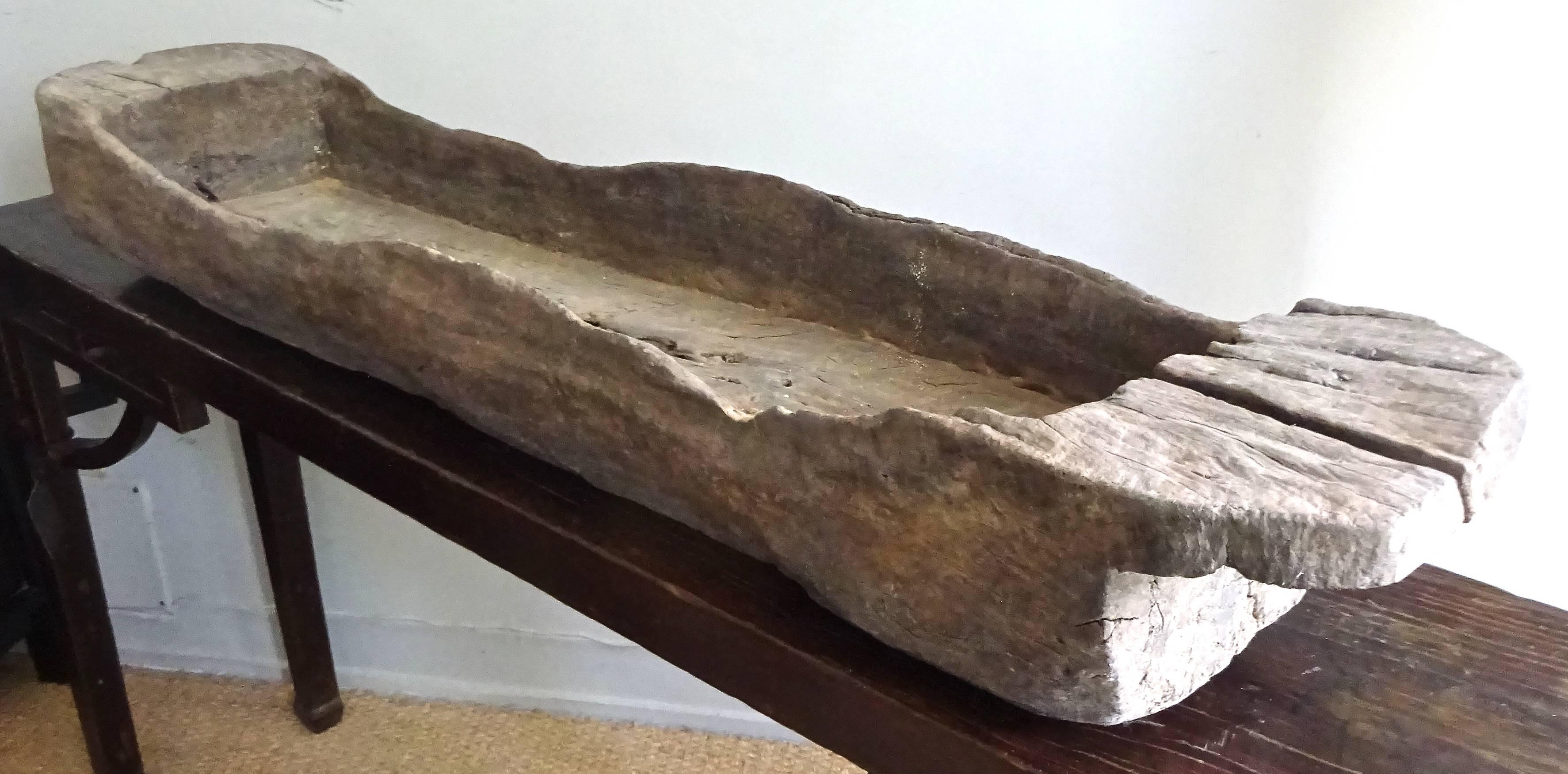 Hand hewn wooden trough cut from one piece of timber. Found in the Yuan Province in rural China.