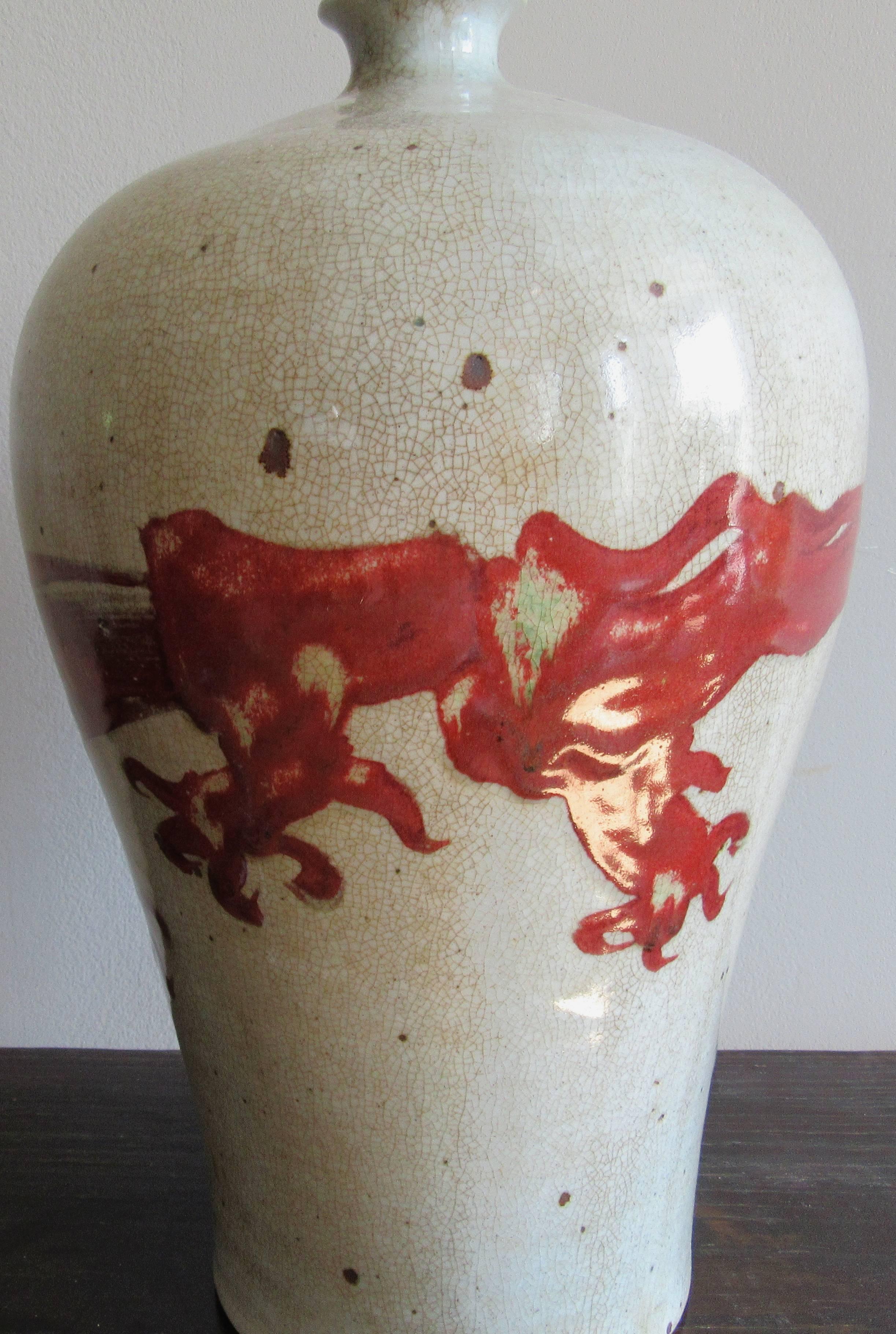Ceramic vessel hand-painted with an abstracted dragon motif. Originally created in southern China for export to Indonesia.