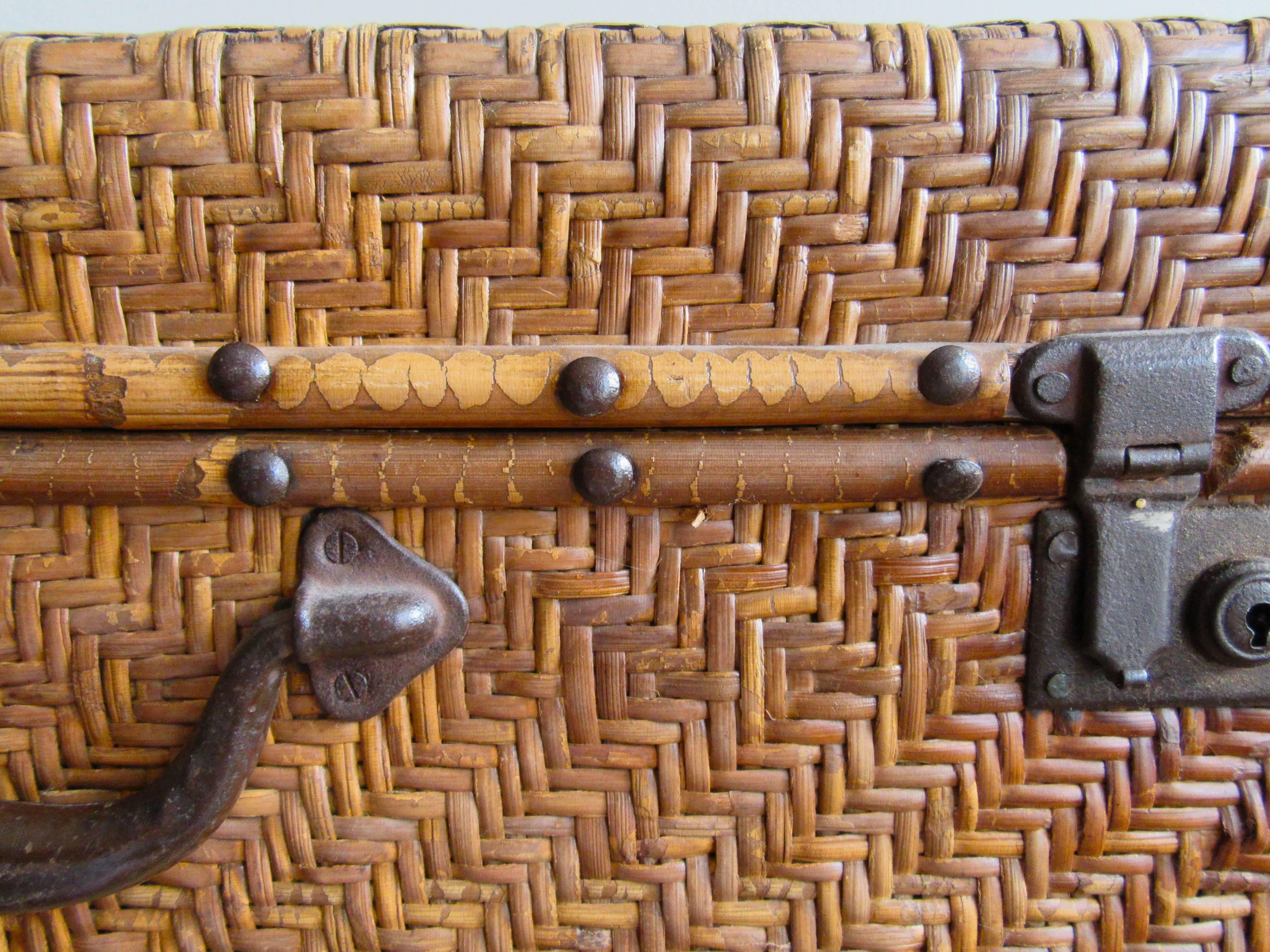 Two suitcases constructed of rattan applied over a wooden form with original hardware.