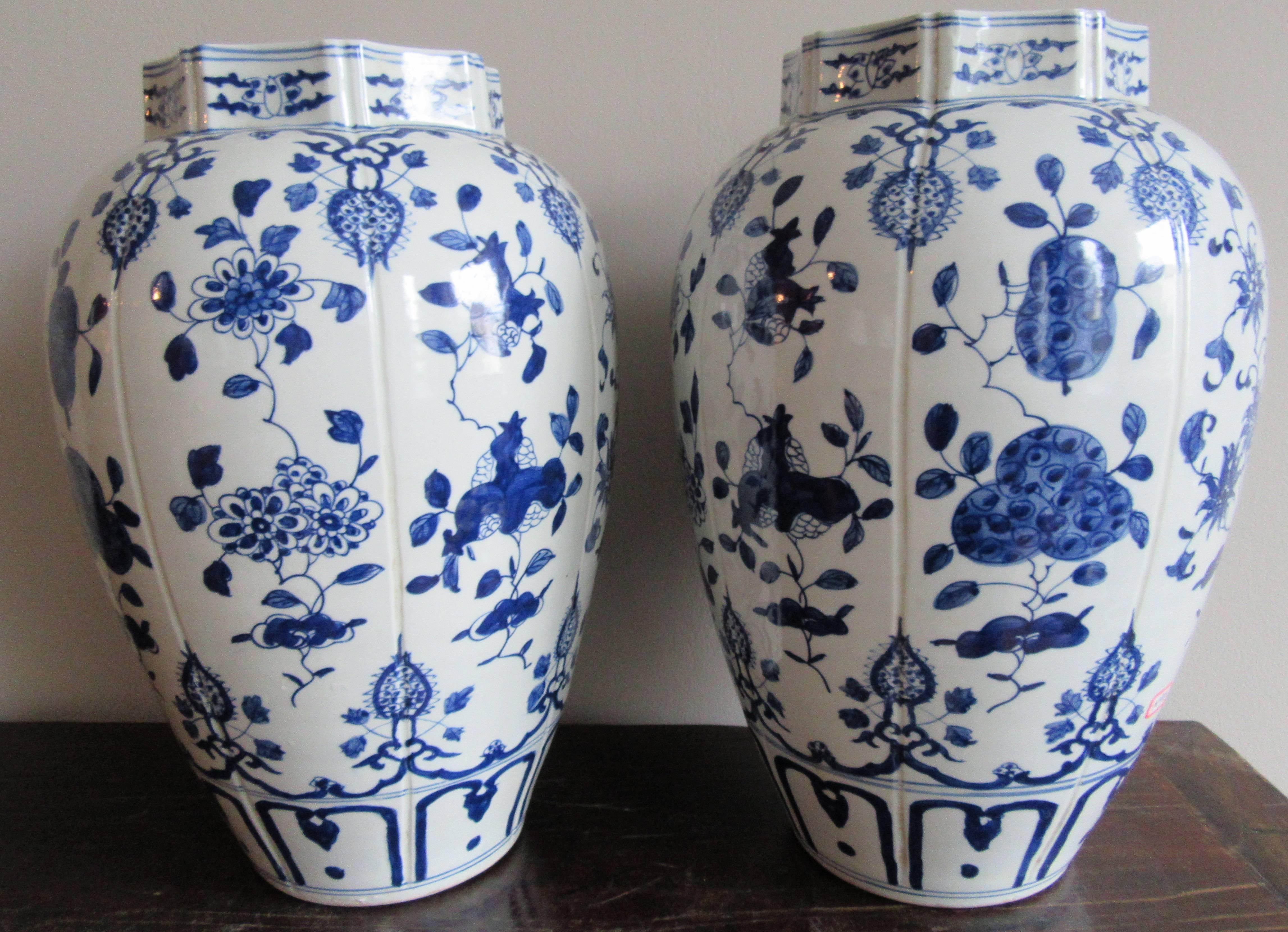 Exceptional pair of Chinese blue and white porcelain vases hand-painted with a crysanthemum flower motif on a ribbed form. This pair of vases was found in the markets of Jingdezhen, China, home of the imperial kilns.