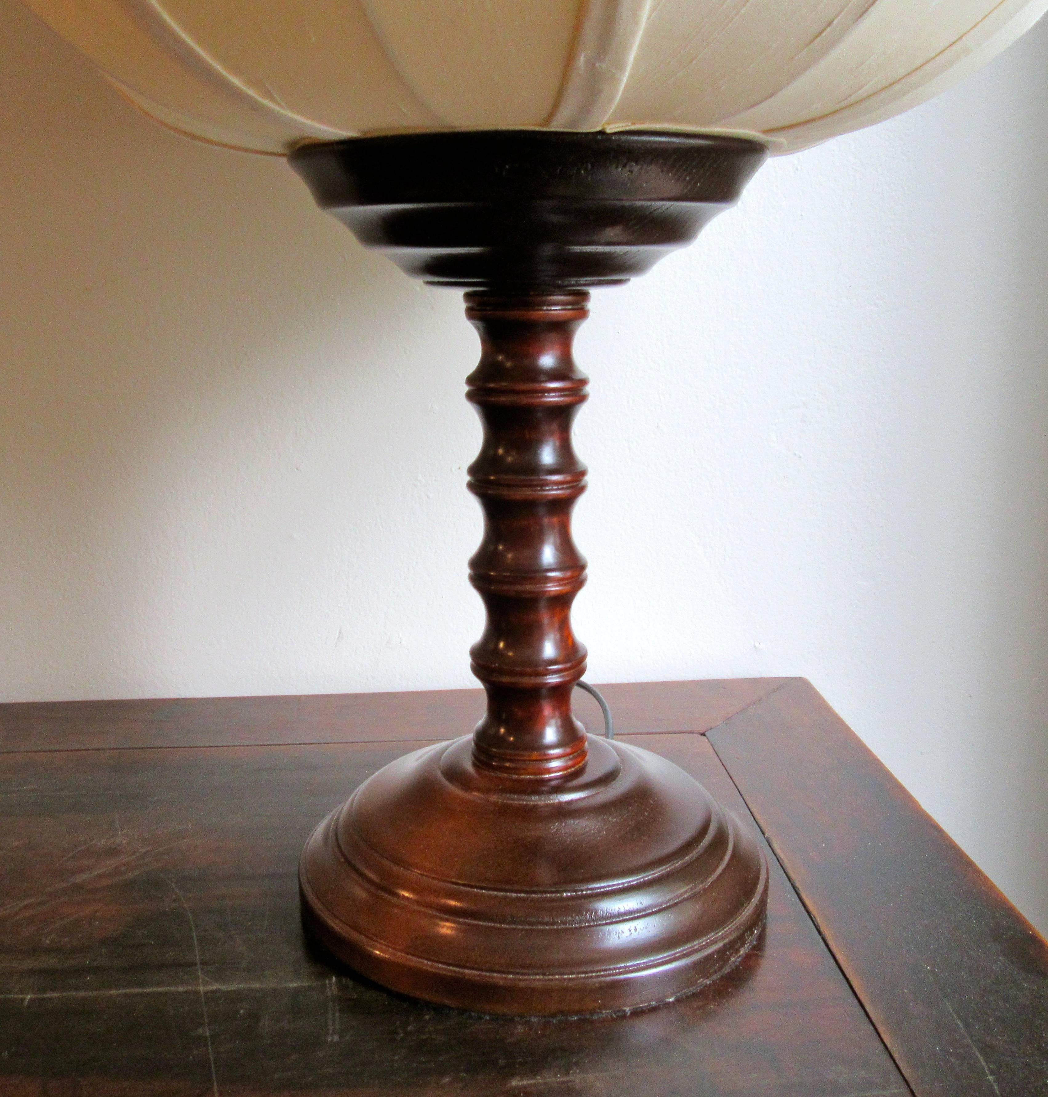 Traditional Chinese lantern shaped table lamp with silk shade and wooden base.