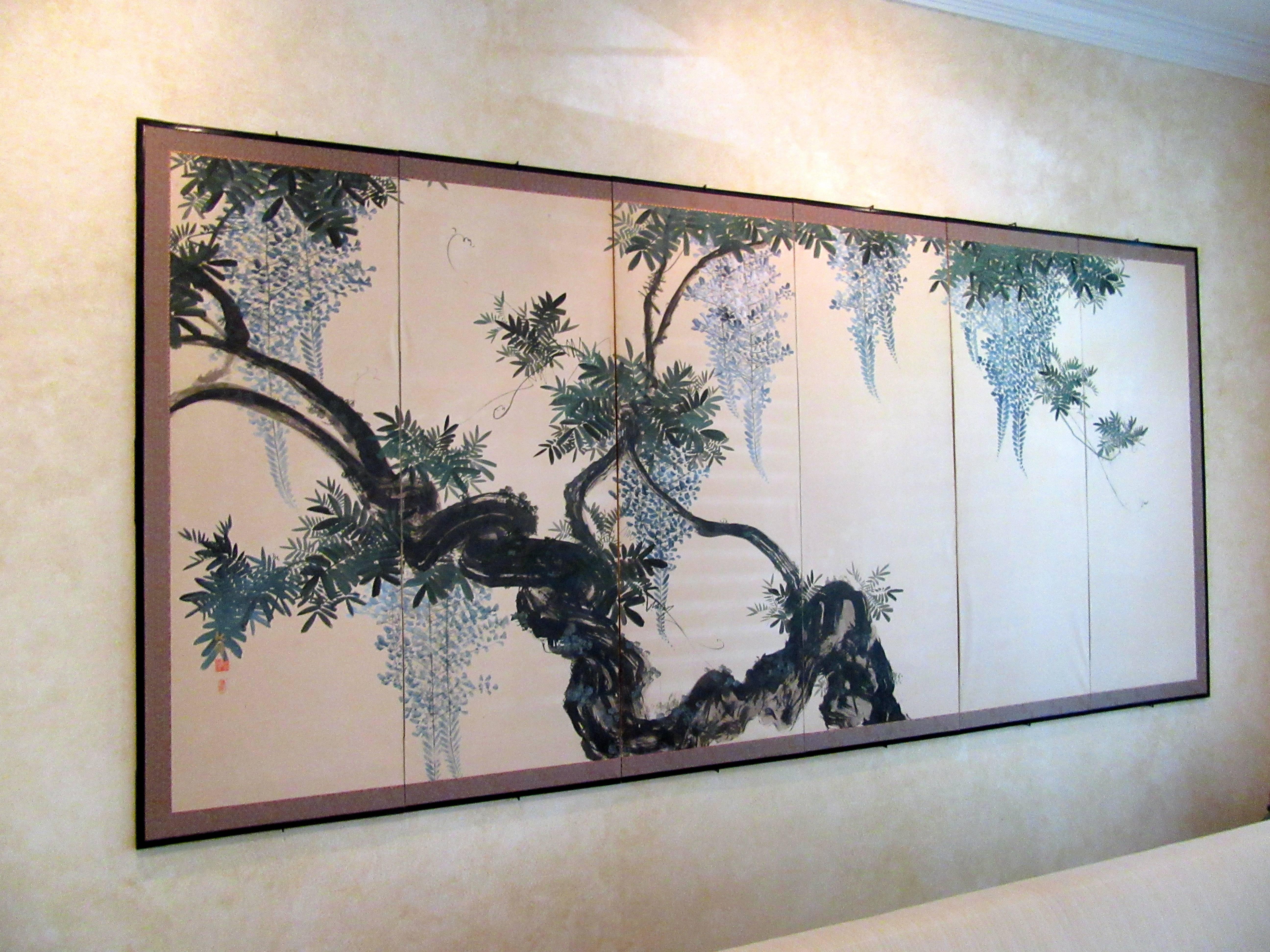 Antique six panel folding screen (Byobu) in ink and colors on paper, mounted on wooden frames with paper hinges, brcade borderand lacquered molding, depicting gnarled trunk and gracefully twisted vines of wisteria in full bloom.
Era: Early 20th