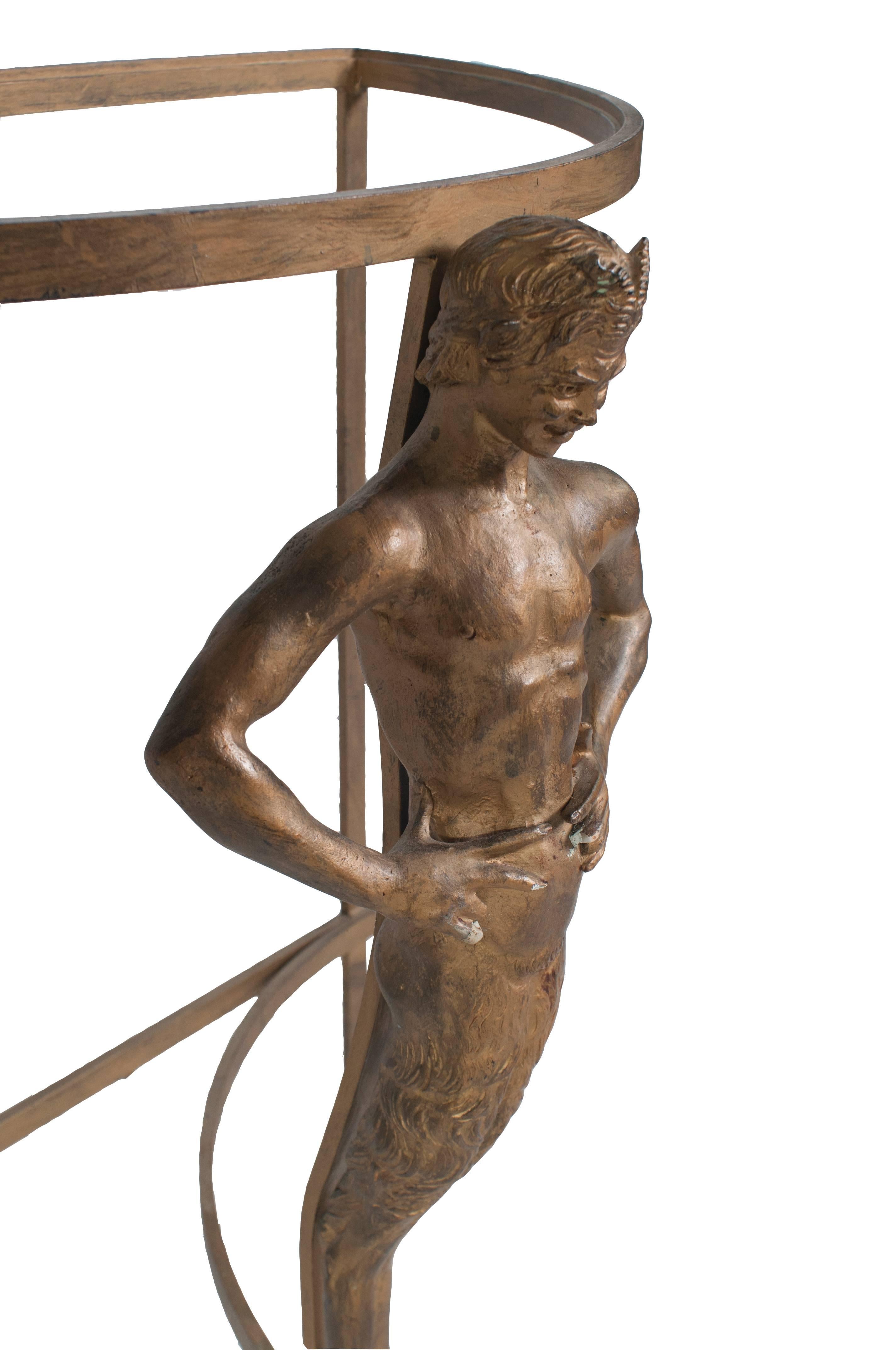 Metal demilune table with a faun leg and glass top.
